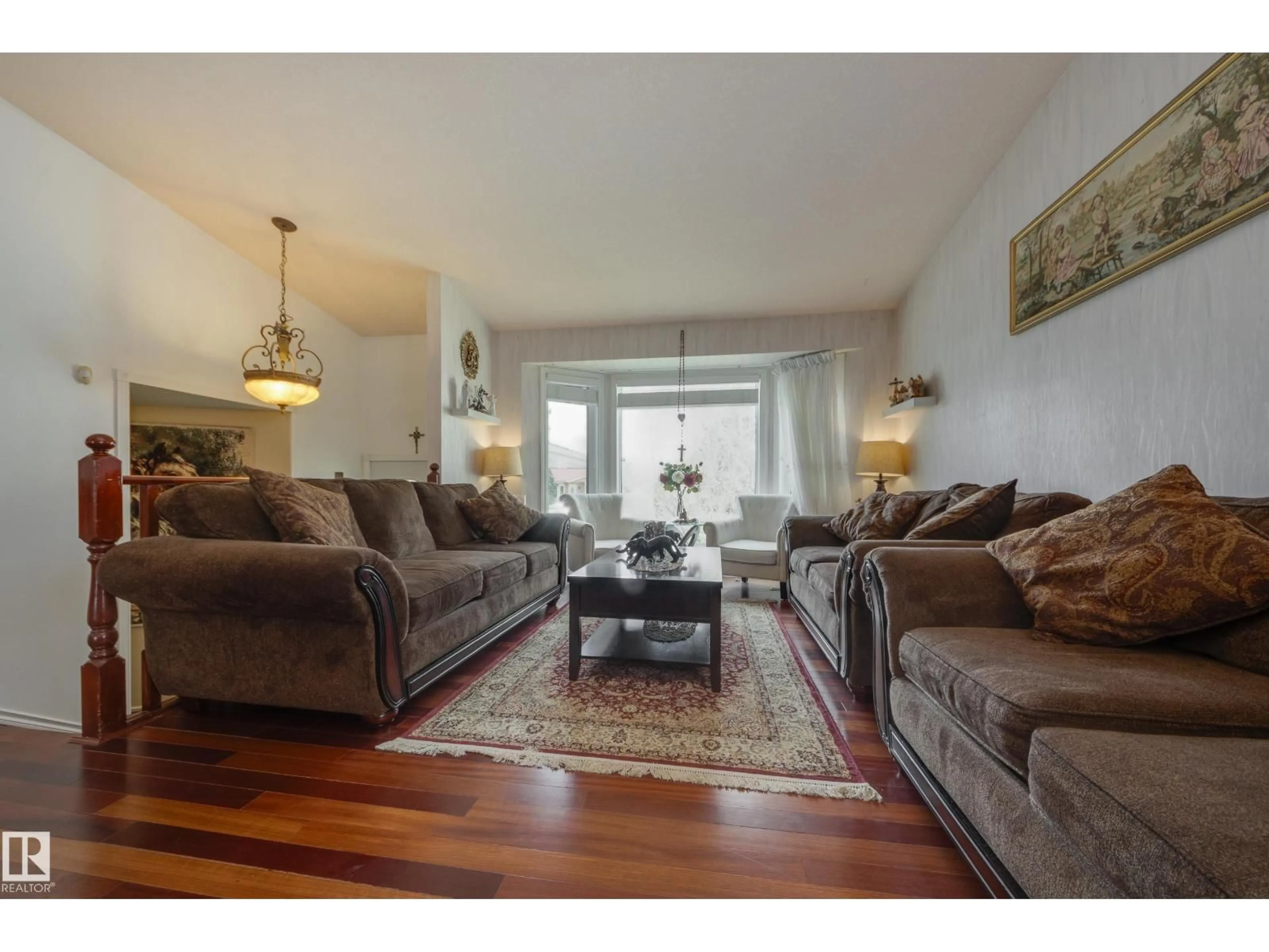 Living room with furniture, wood/laminate floor for 6217 13 AV, Edmonton Alberta T6L2E5