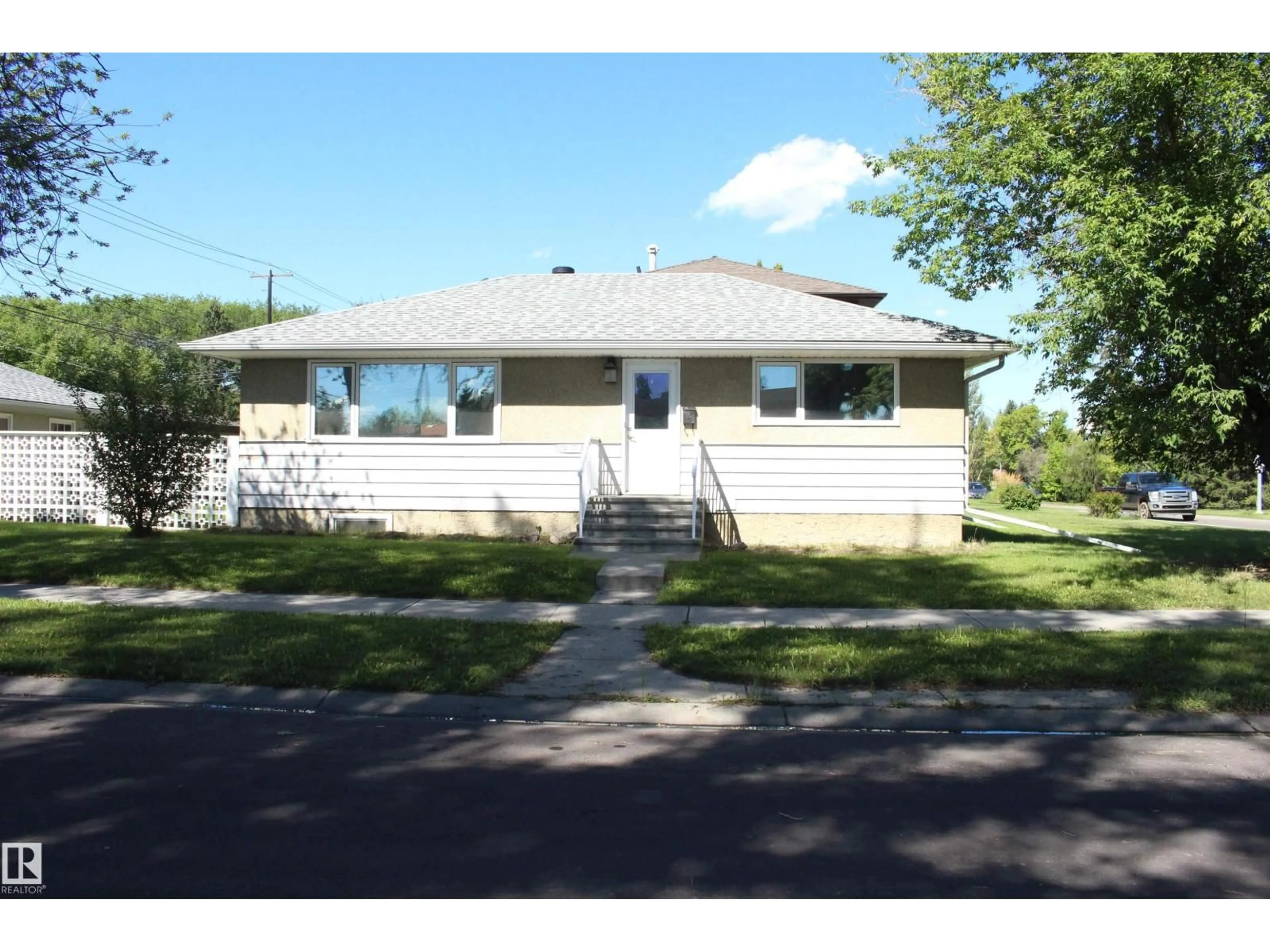 Home with vinyl exterior material, street for 7504 77 AV, Edmonton Alberta T6C0K5