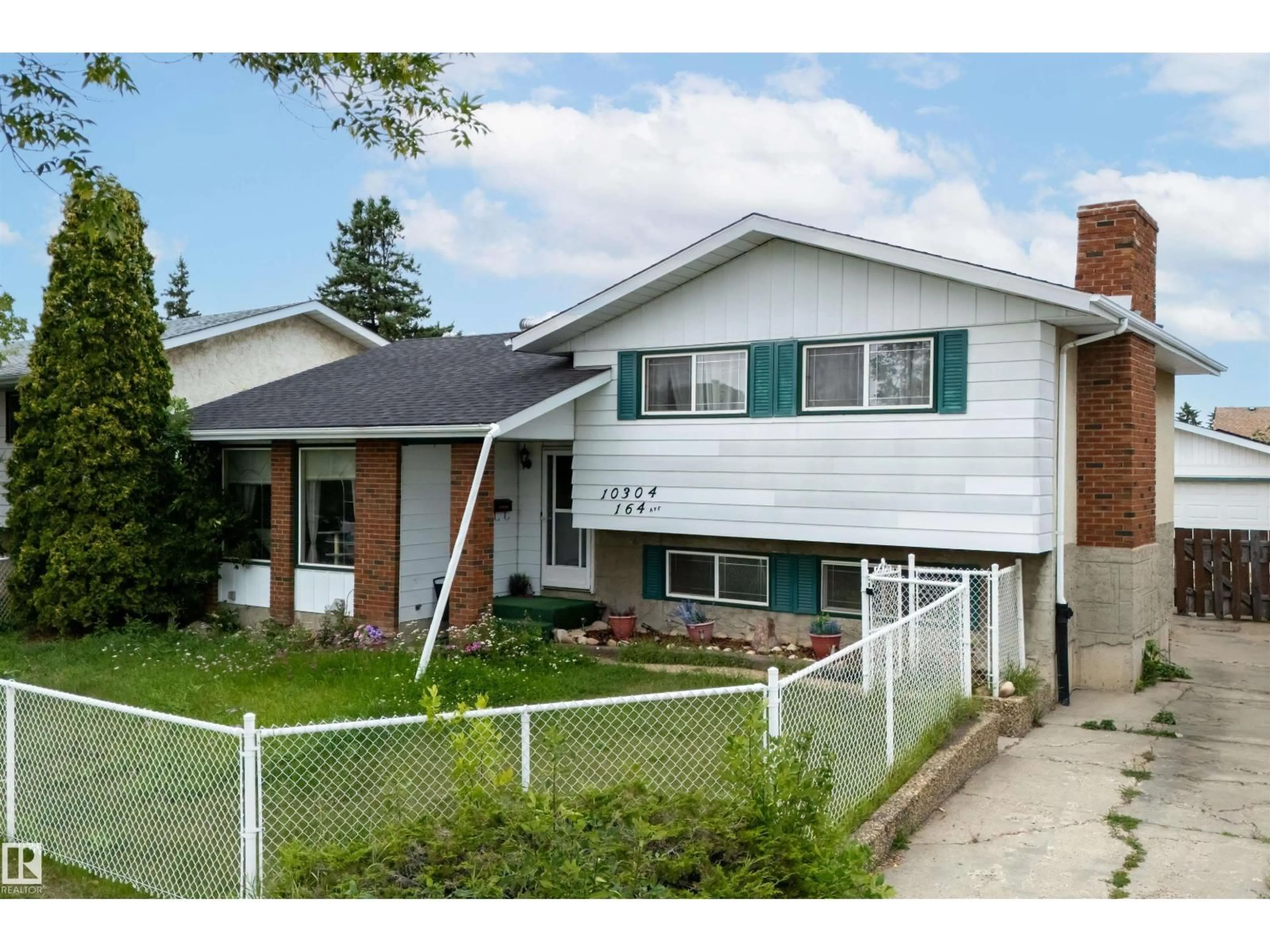 Home with vinyl exterior material, street for 10304 164 AV, Edmonton Alberta T5X2E2