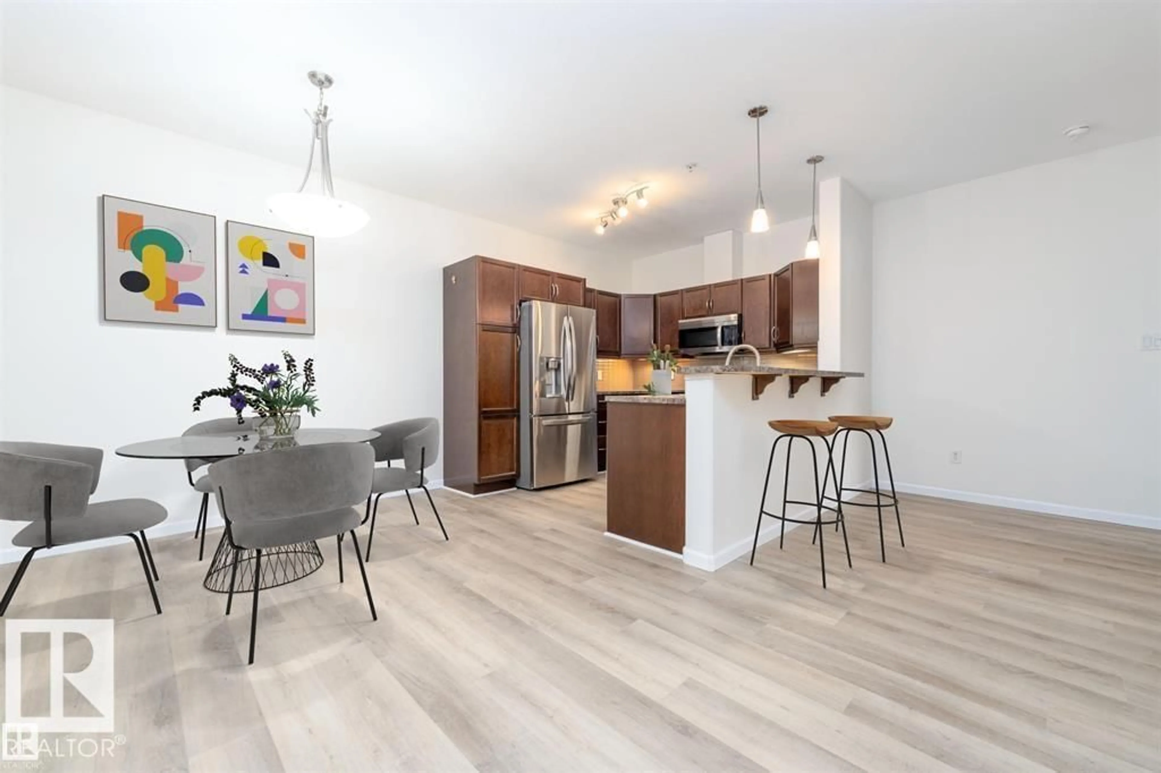 Open concept kitchen, wood/laminate floor for #131 - 2503 HANNA CR, Edmonton Alberta T6R0H1