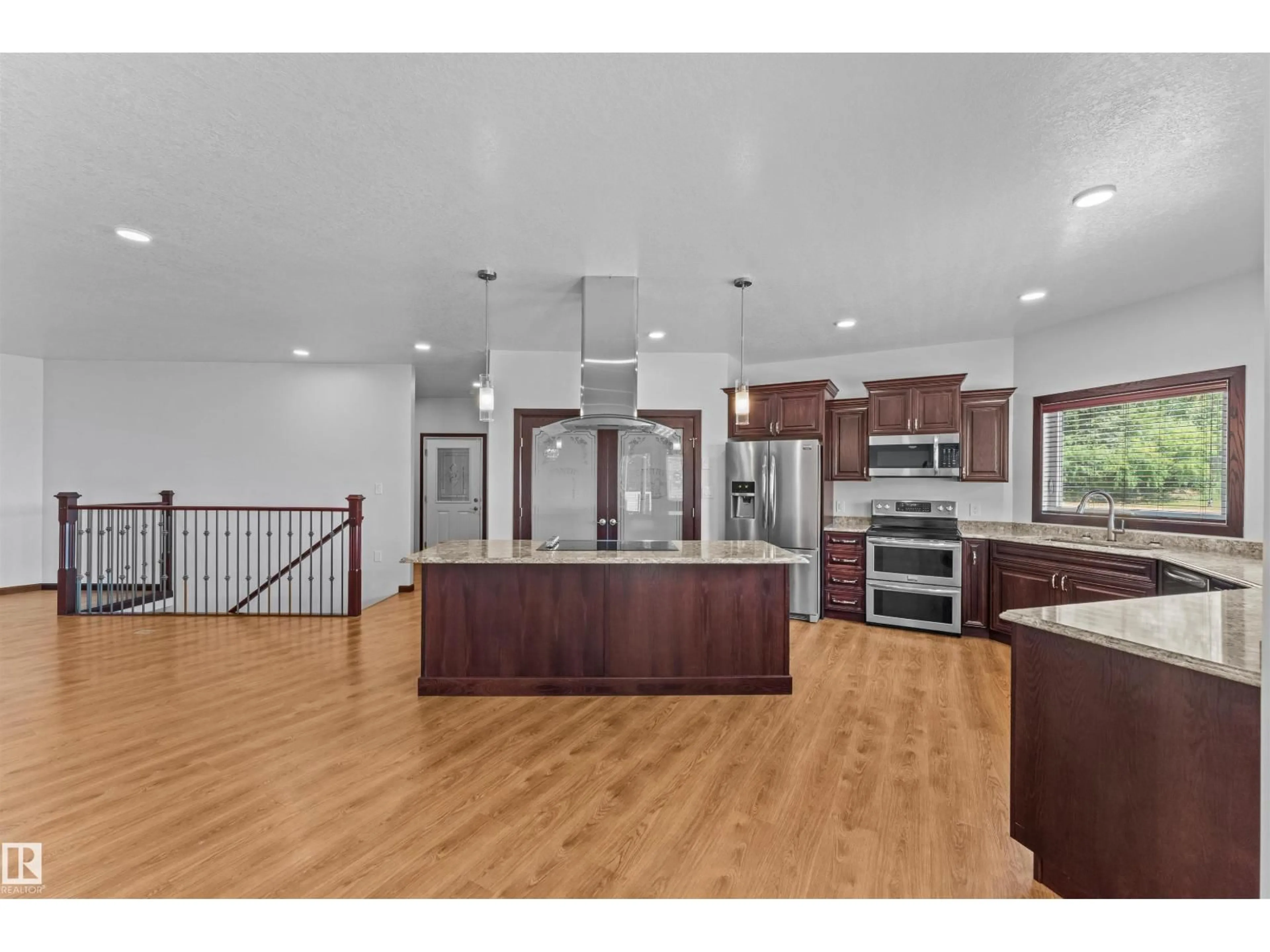Open concept kitchen, wood/laminate floor for 564032-564034 RANGE ROAD 130, Rural Two Hills County Alberta T0B0P0
