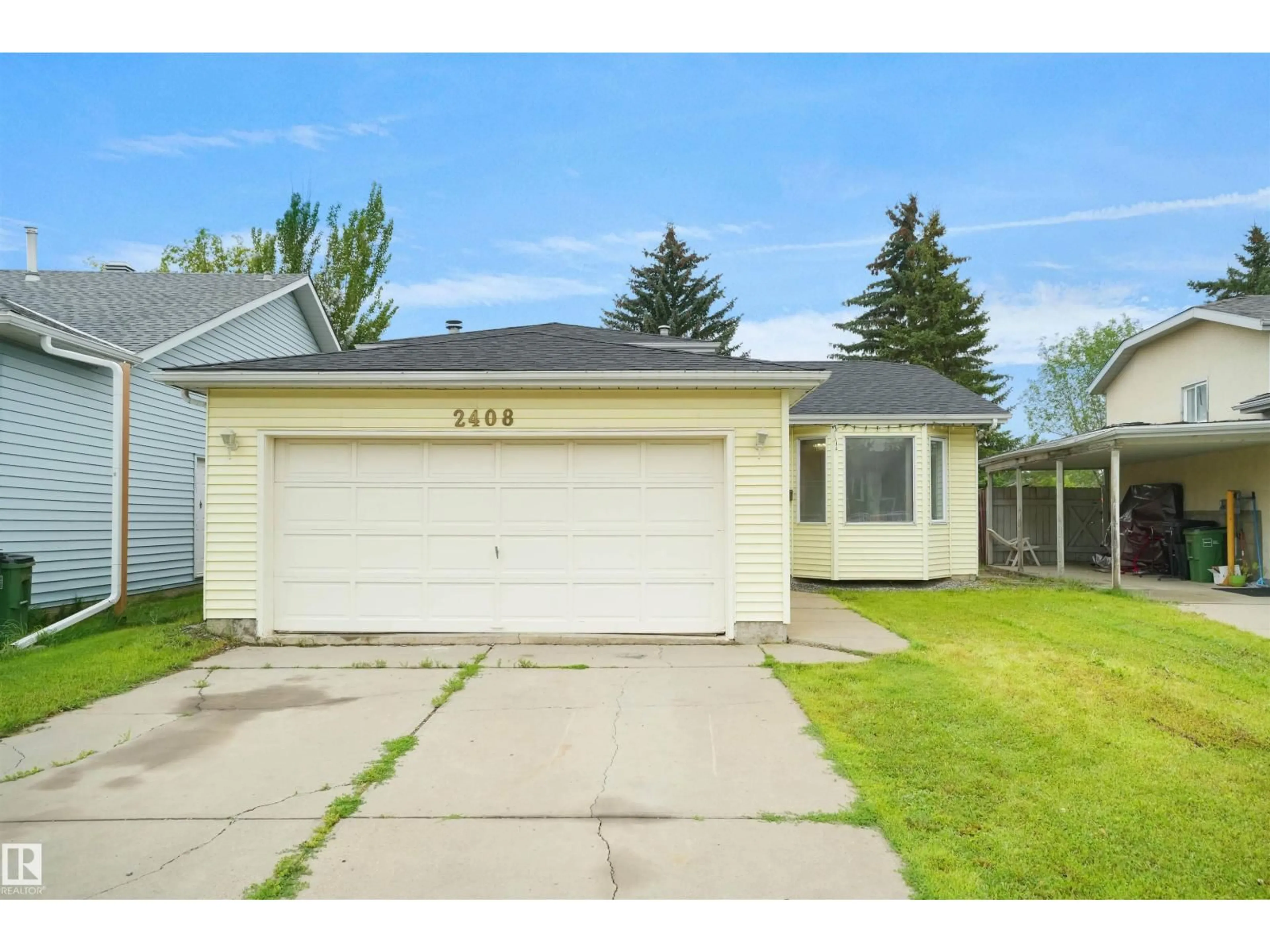 Home with vinyl exterior material, street for 2408 49A ST, Edmonton Alberta T6L6E1