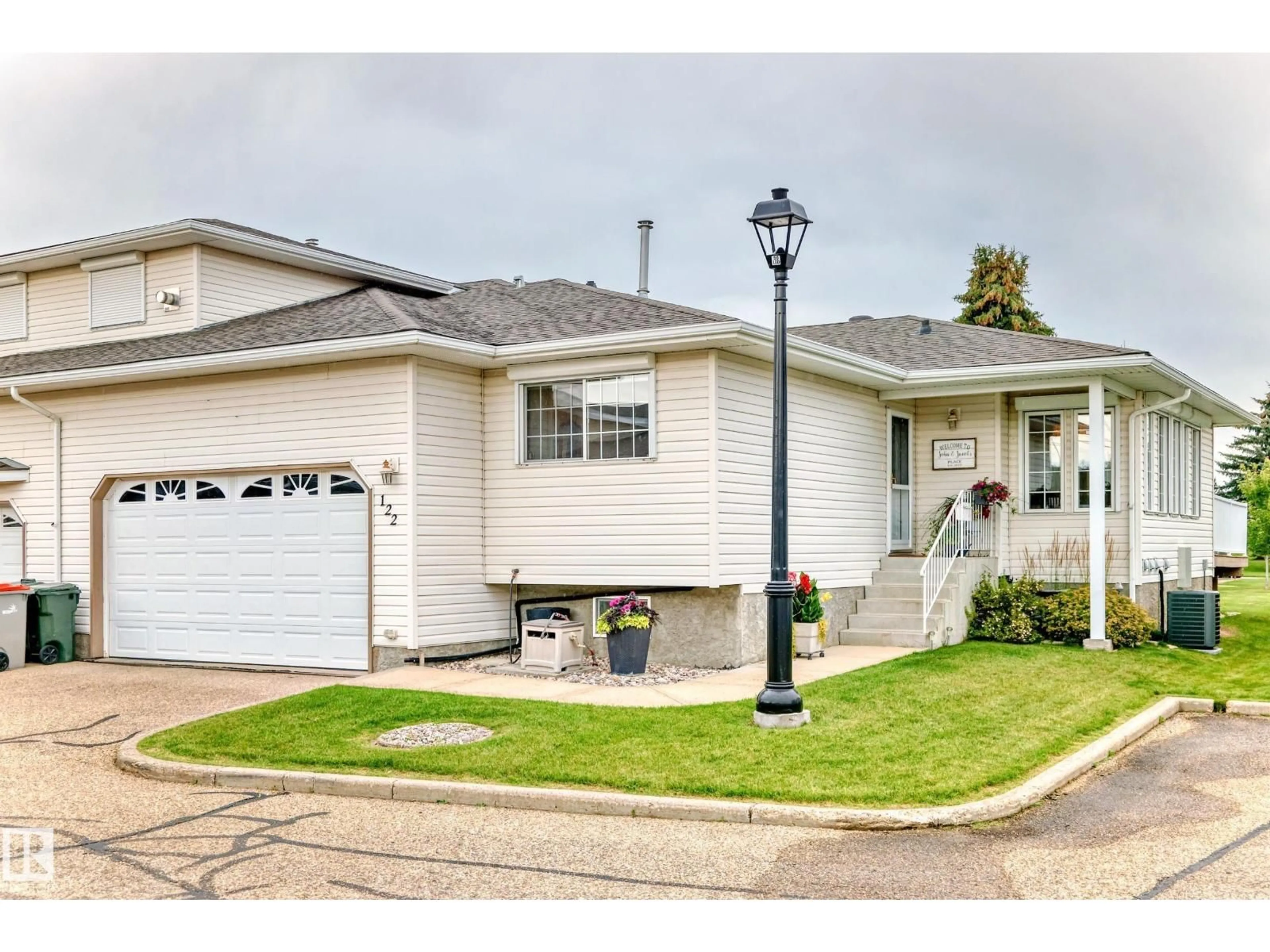 Home with vinyl exterior material, street for 122 - 4610 50 AV, Stony Plain Alberta T7Z1P4