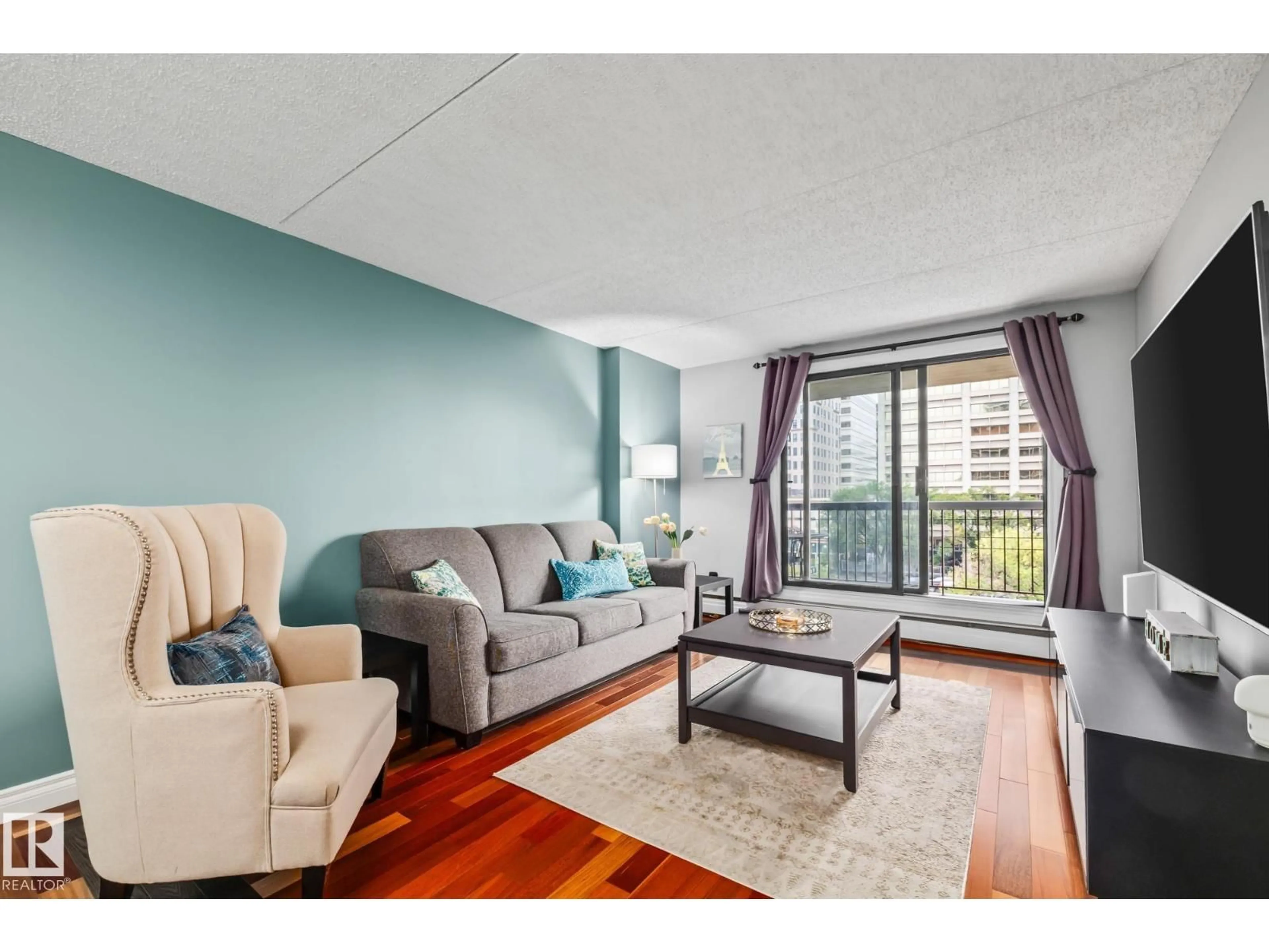 Living room with furniture, wood/laminate floor for 508 9917 110 ST NW, Edmonton Alberta T5K2N4