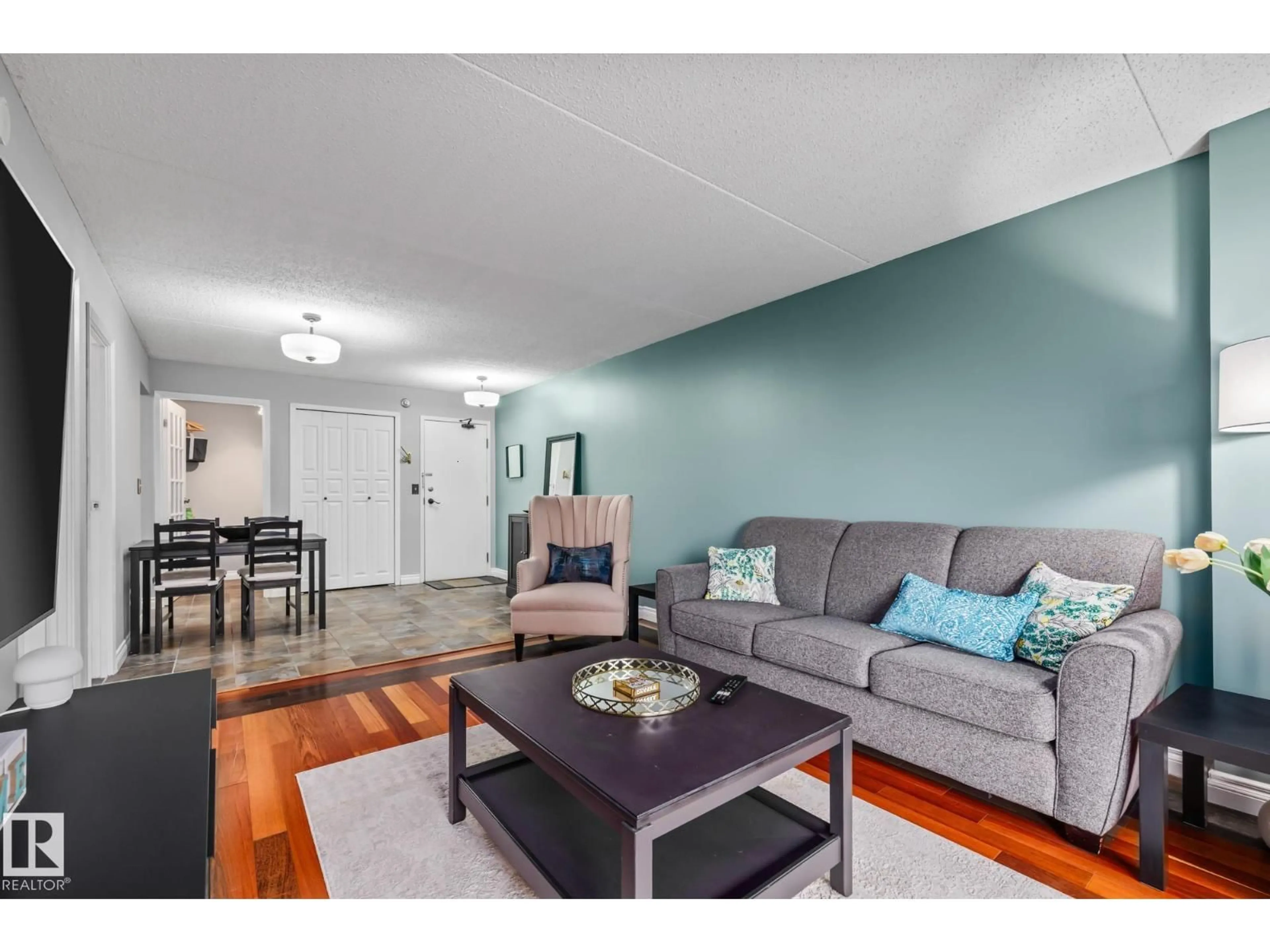Living room with furniture, wood/laminate floor for 508 9917 110 ST NW, Edmonton Alberta T5K2N4