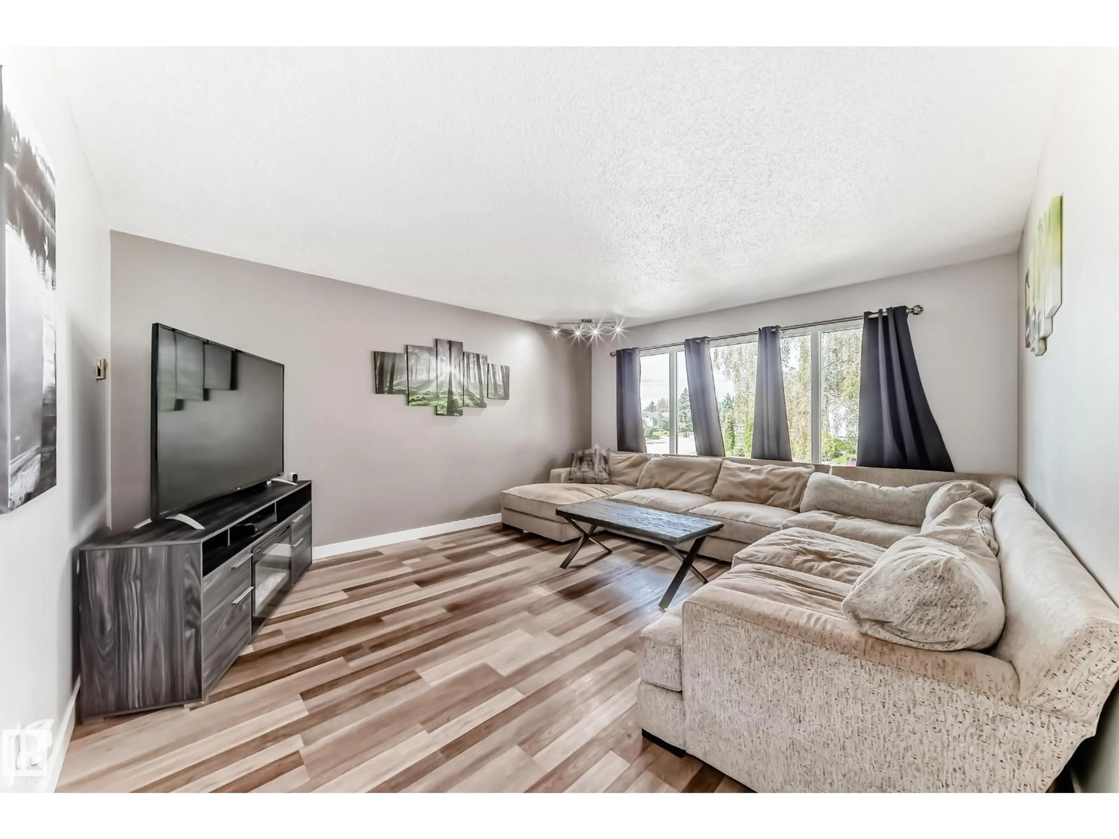 Living room with furniture, wood/laminate floor for 8803 16 AV, Edmonton Alberta T6K2A4