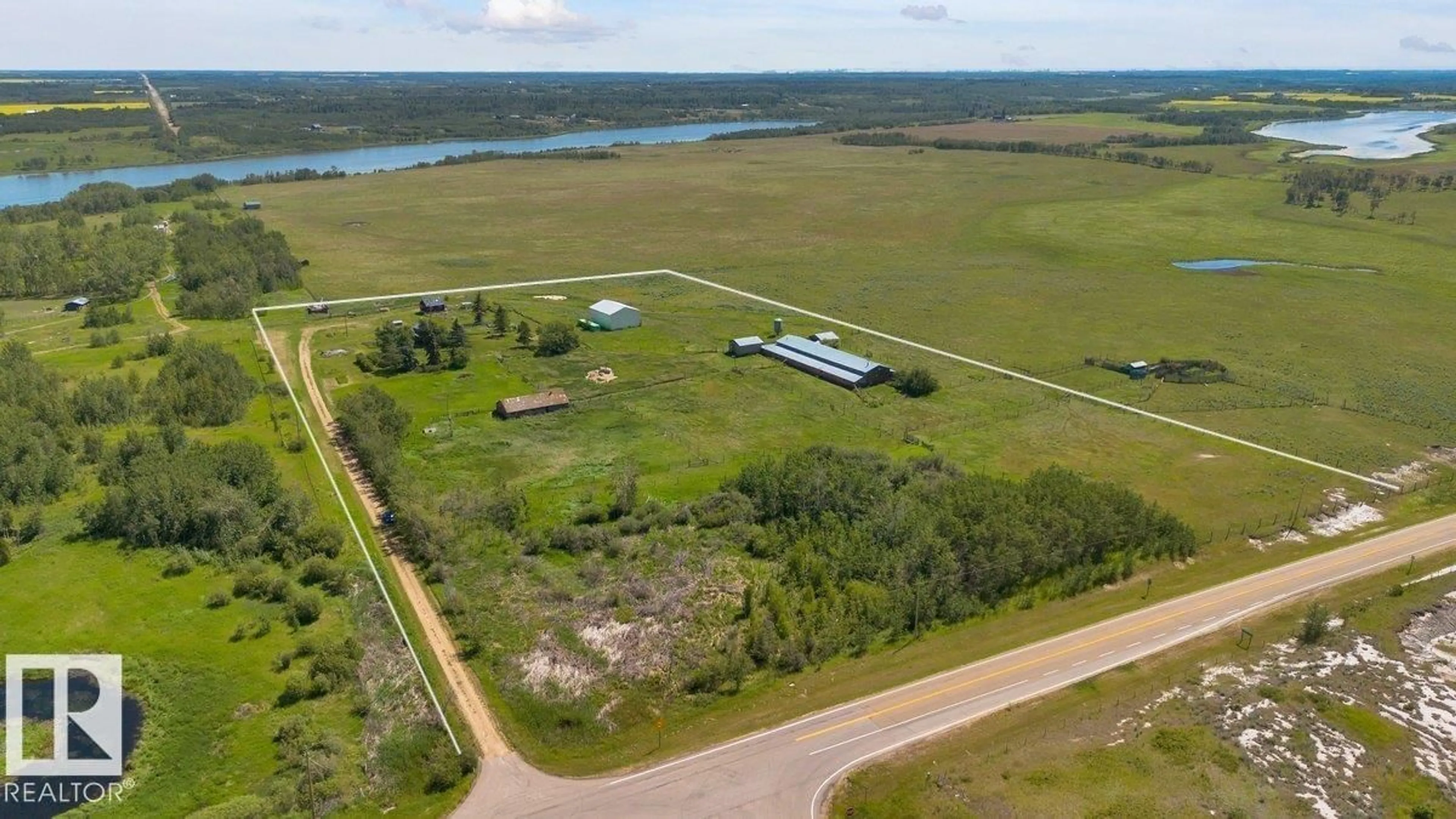 A pic from outside/outdoor area/front of a property/back of a property/a pic from drone, water/lake/river/ocean view for 23427 TWP RD 574, Rural Sturgeon County Alberta T8R1L2