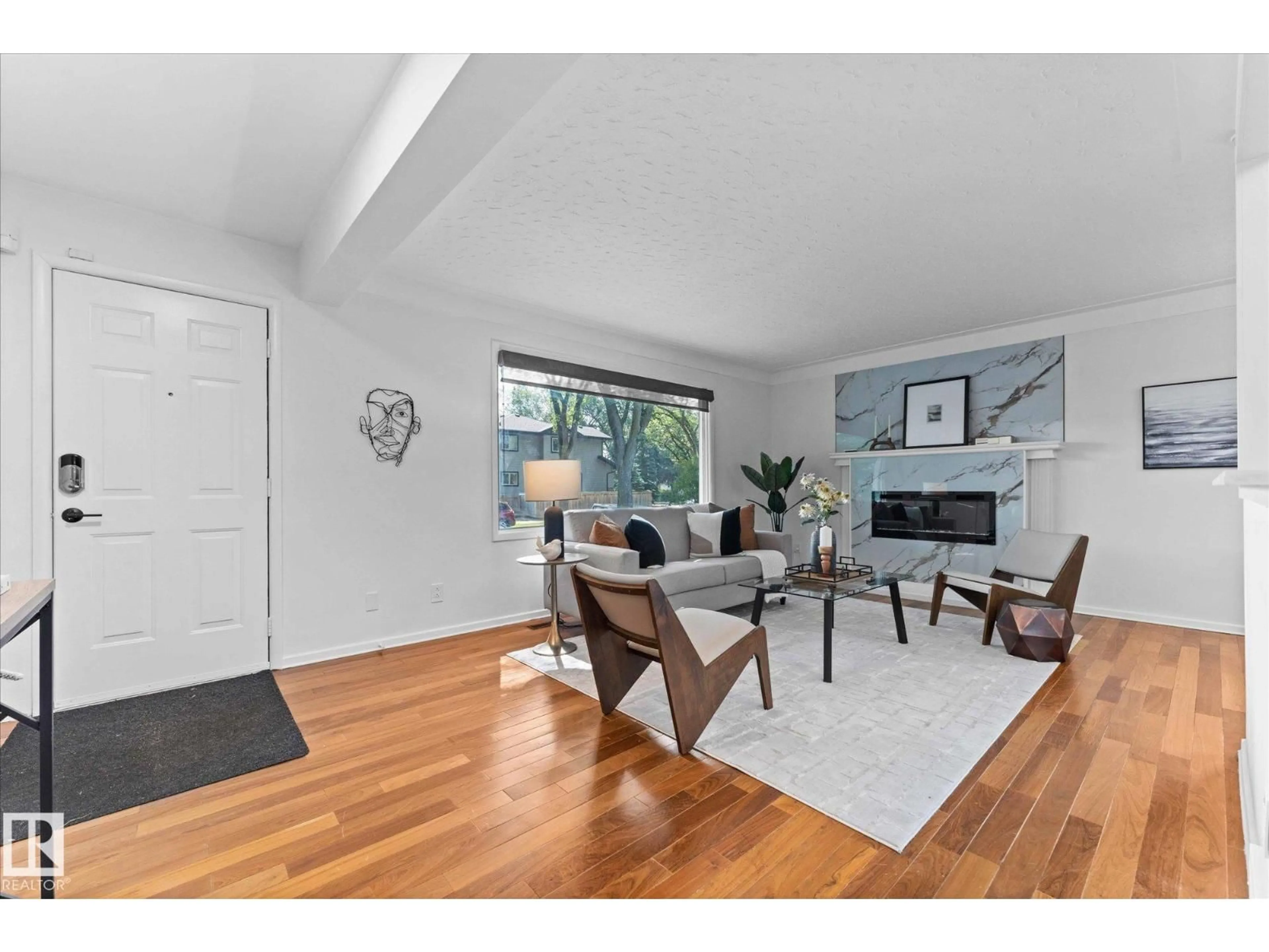 Living room with furniture, wood/laminate floor for 10112 81 ST, Edmonton Alberta T6A3K5