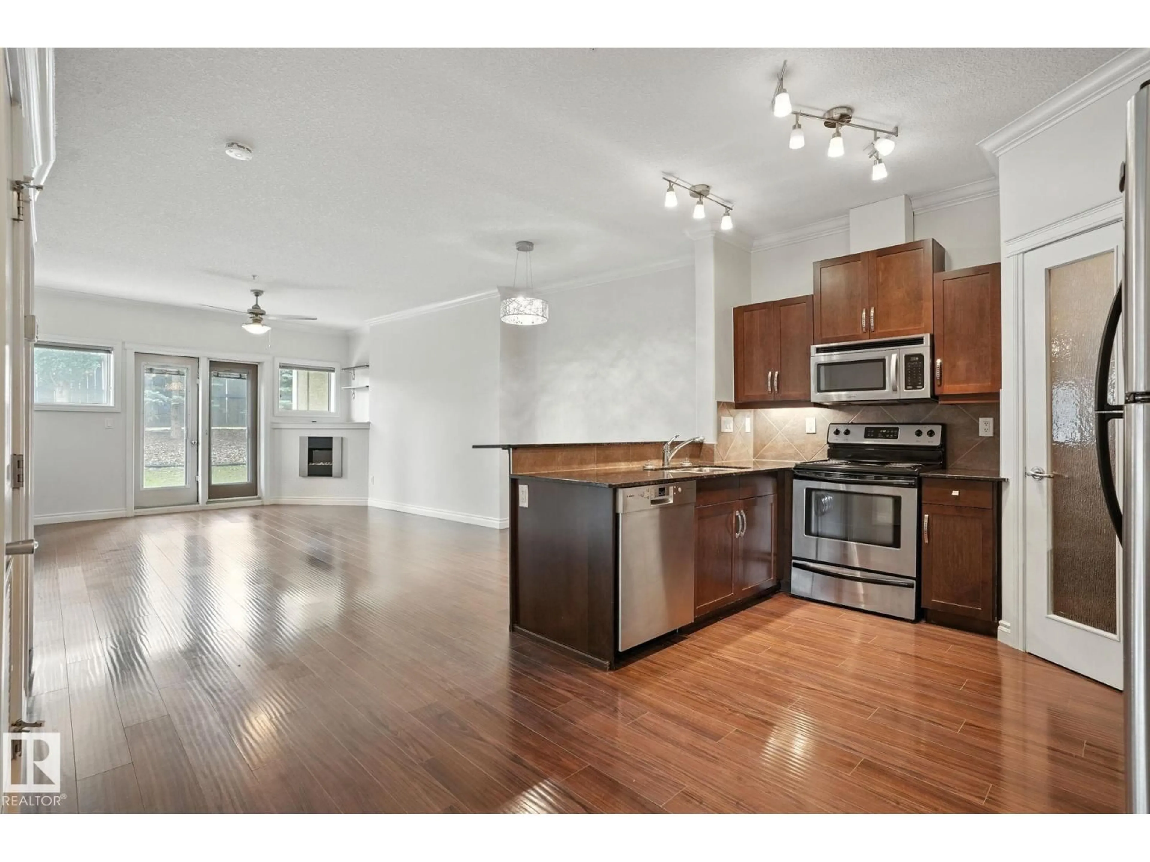 Open concept kitchen, wood/laminate floor for #146 - 10121 80 AV, Edmonton Alberta T6E0B9