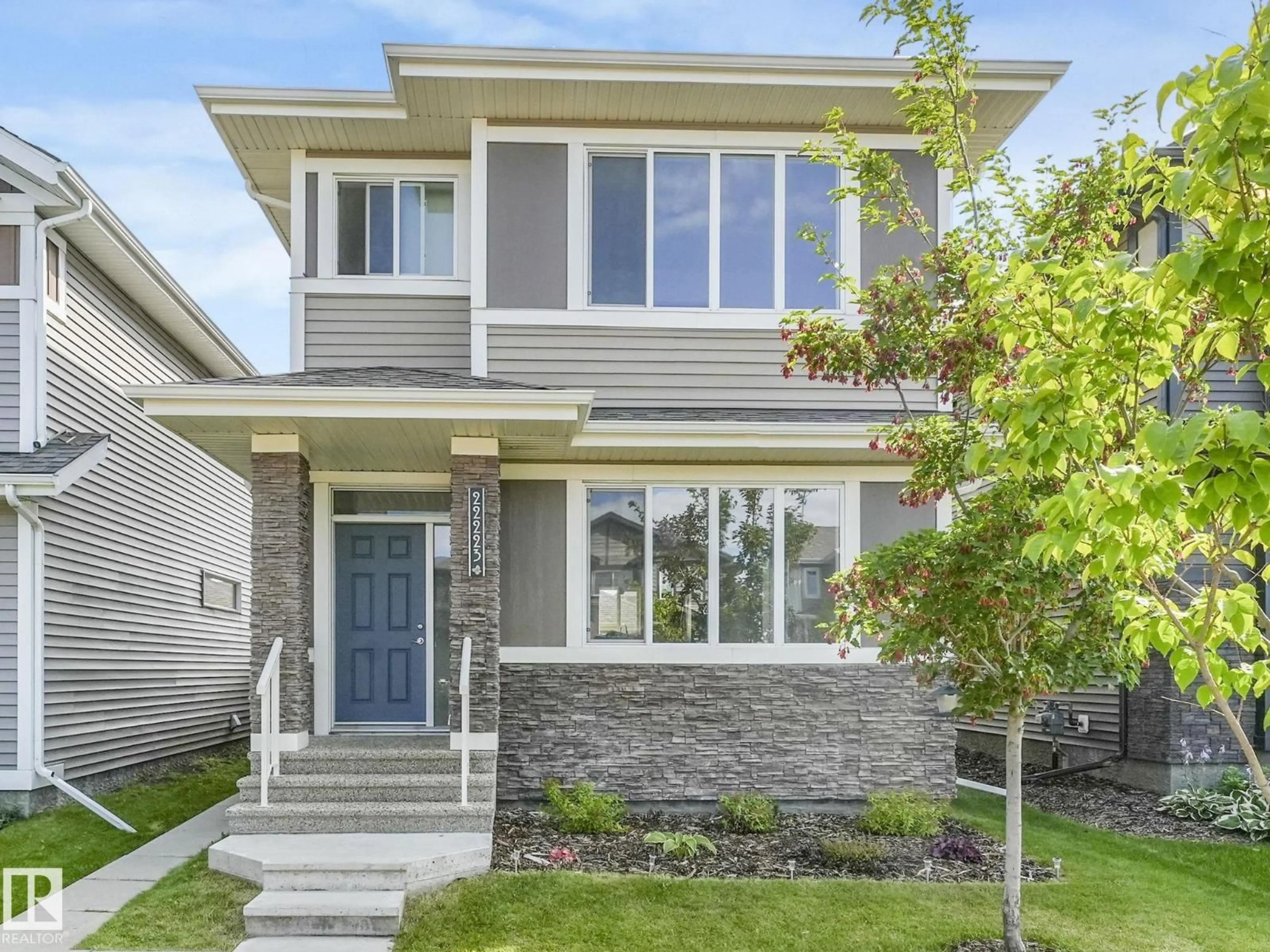 Home with vinyl exterior material, street for NW - 22223 89 AV, Edmonton Alberta T5T7H1