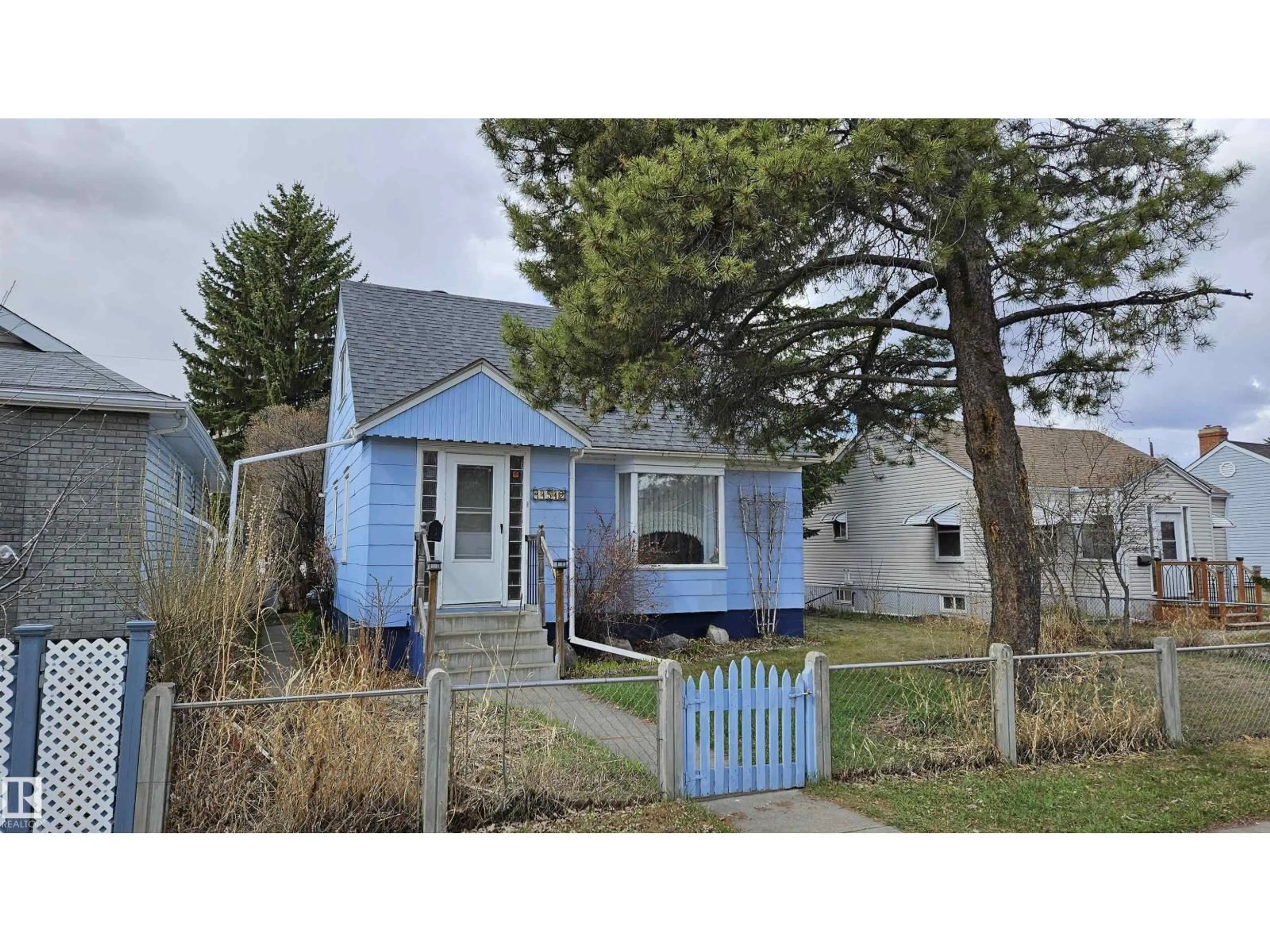 Home with vinyl exterior material, street for NW - 11512 86 ST, Edmonton Alberta T5B3J5