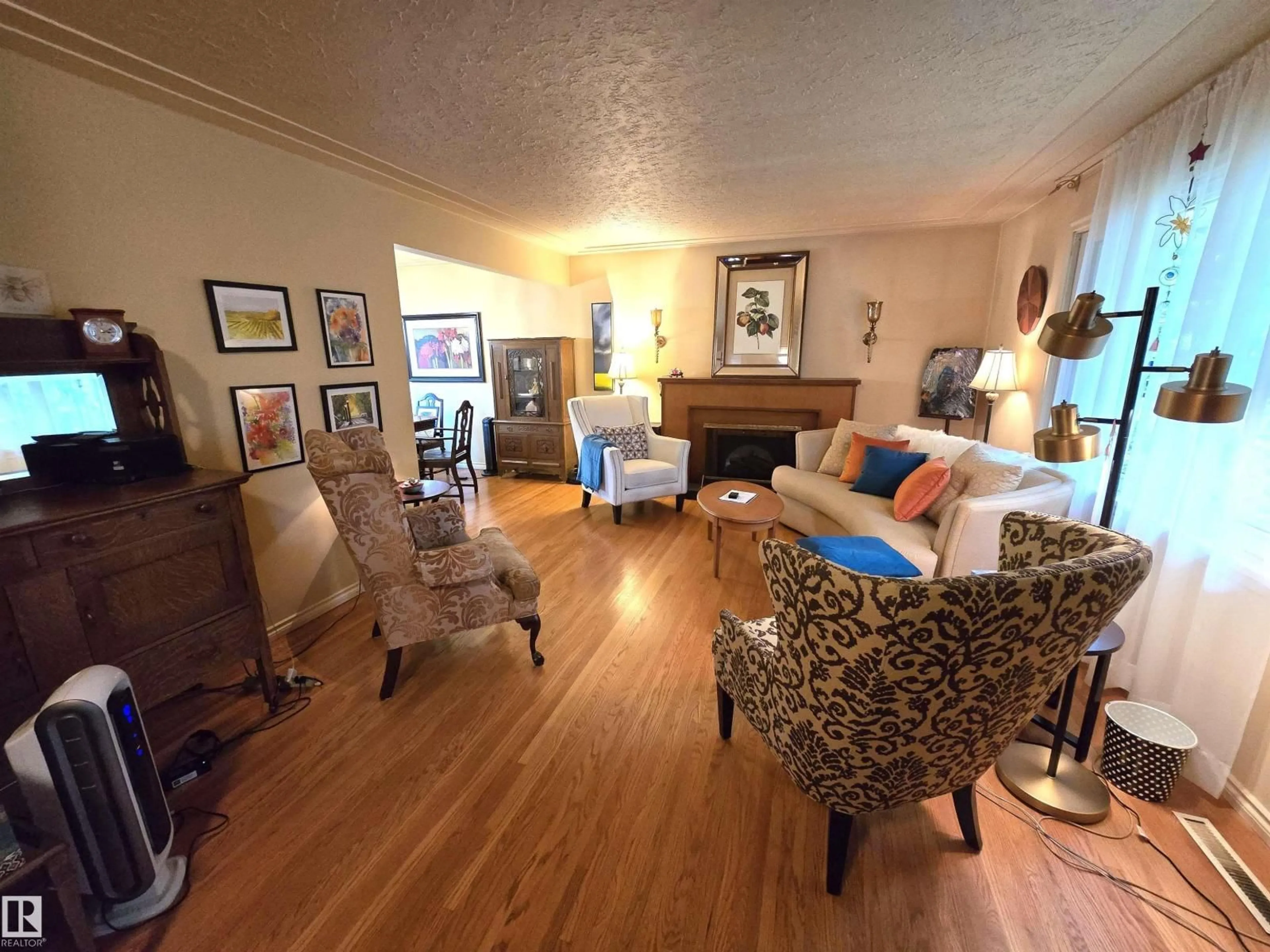 Living room with furniture, wood/laminate floor for 13924 107A AV, Edmonton Alberta T5M2A9