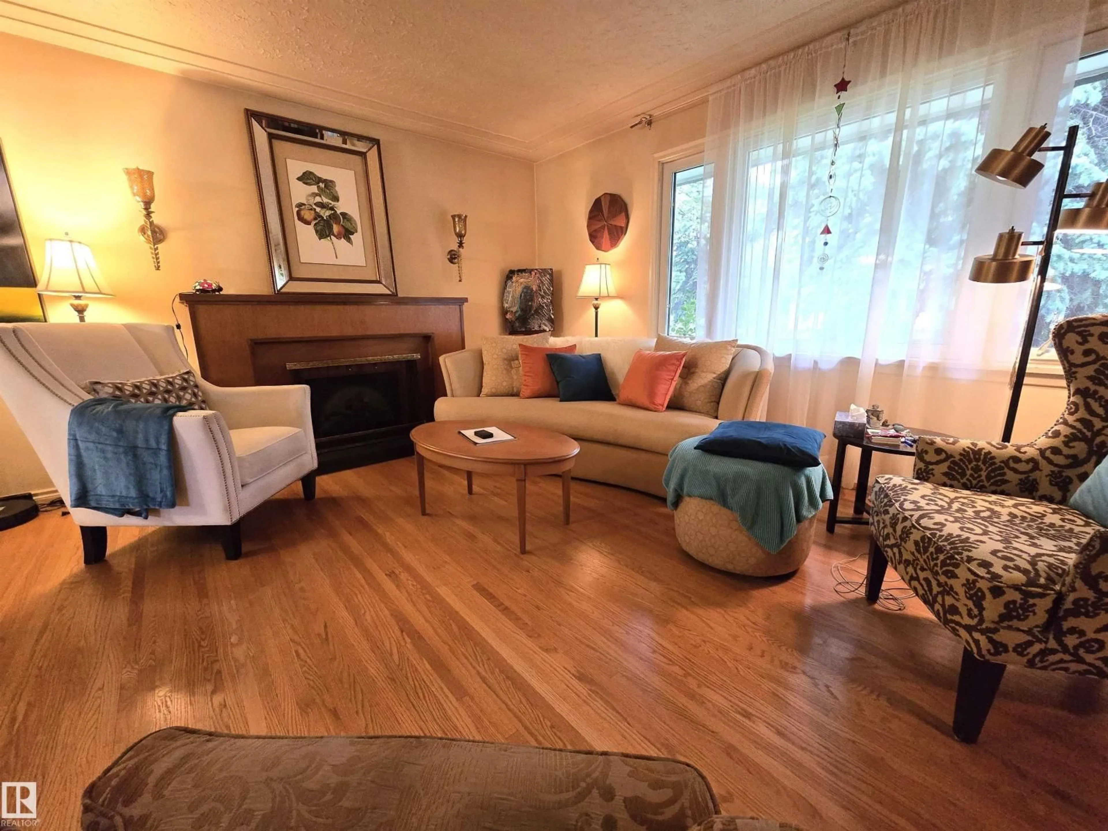 Living room with furniture, wood/laminate floor for 13924 107A AV, Edmonton Alberta T5M2A9