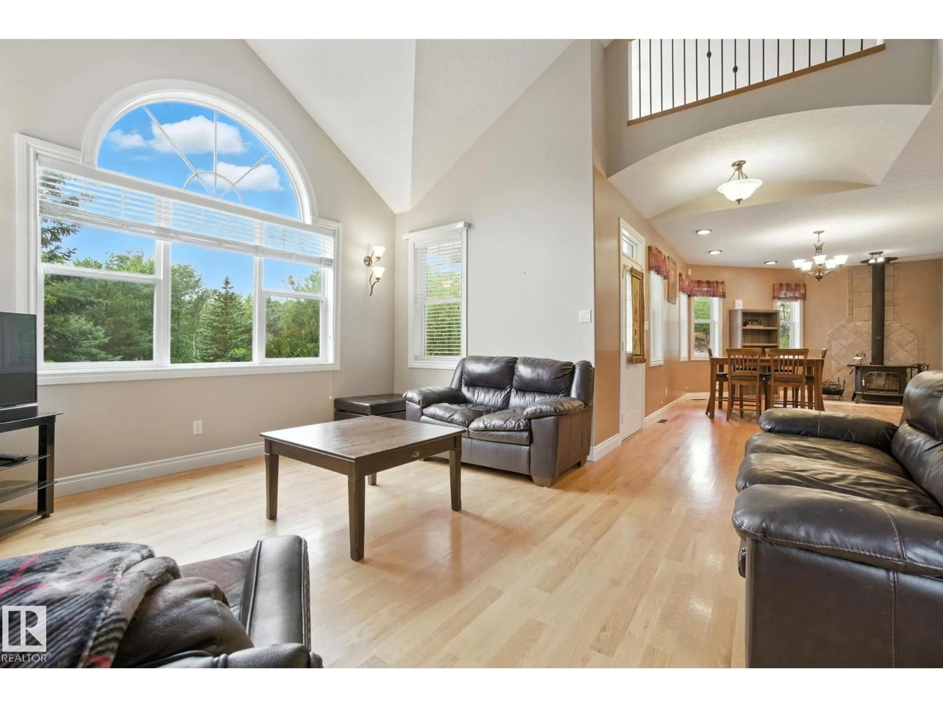 Living room with furniture, wood/laminate floor for 102 POPLAR CRES, Rural Parkland County Alberta T7Z2V3
