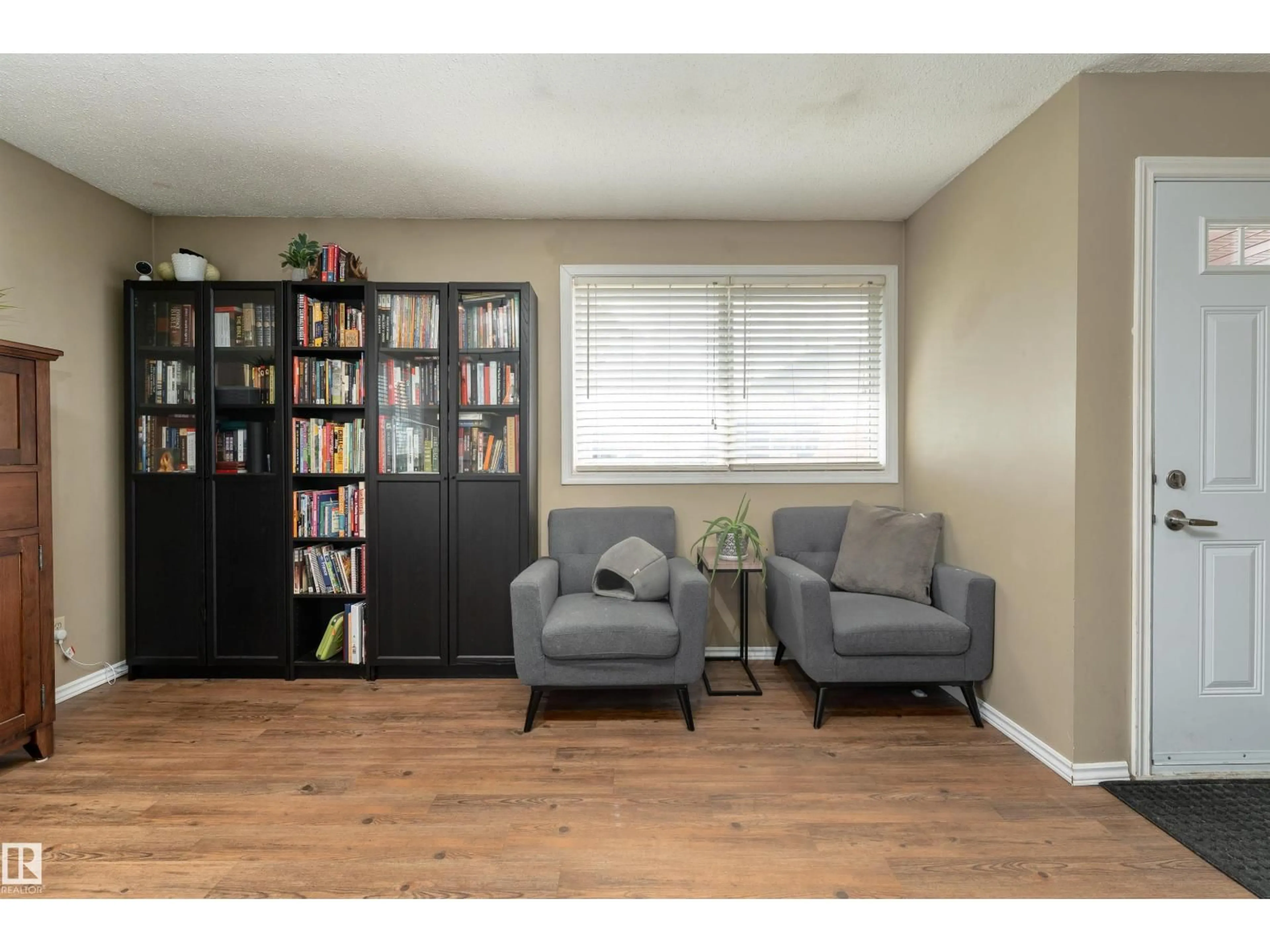 Living room with furniture, wood/laminate floor for #118 - 8930 99 AV, Fort Saskatchewan Alberta T8L3L1