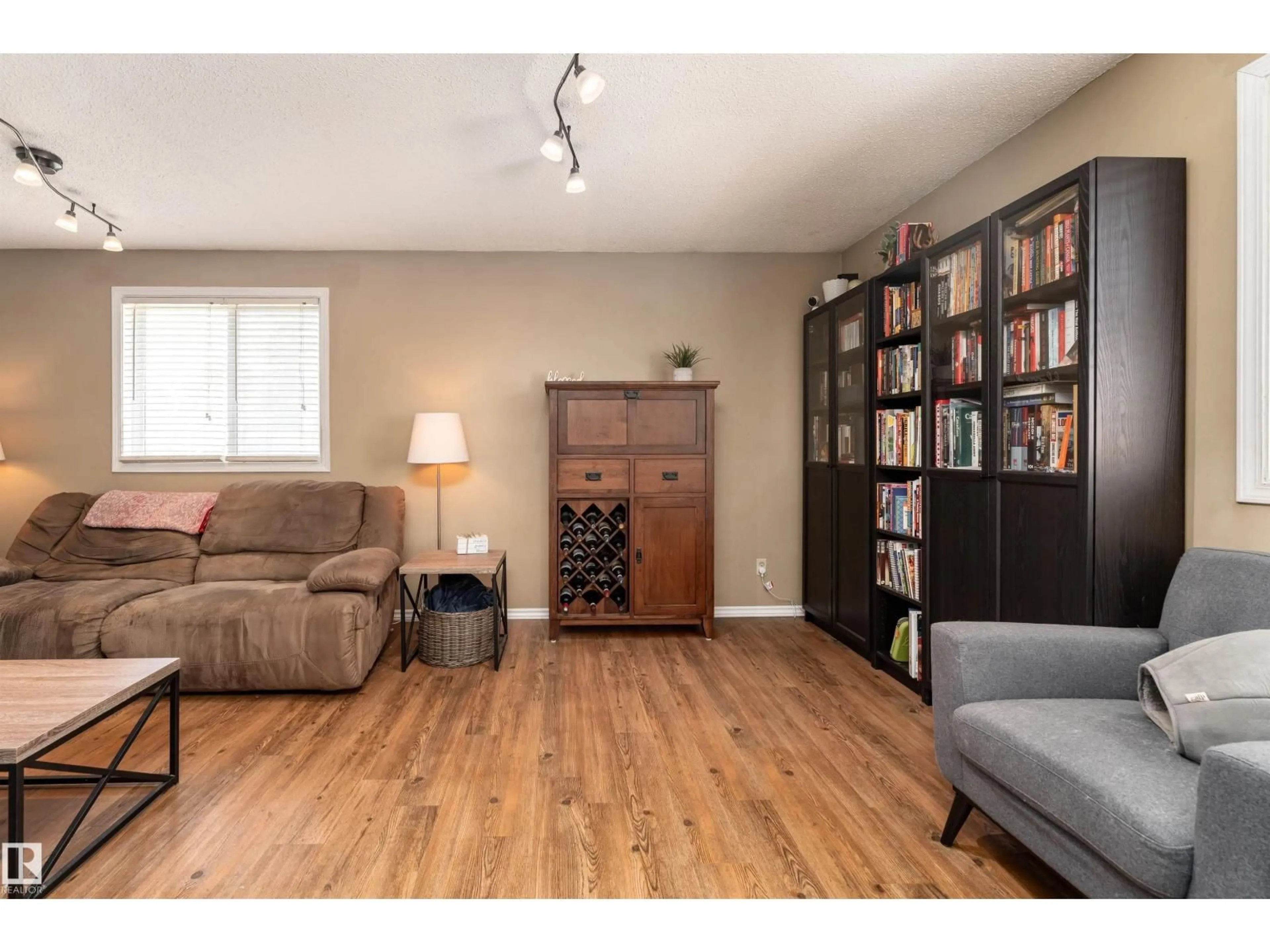 Living room with furniture, wood/laminate floor for #118 - 8930 99 AV, Fort Saskatchewan Alberta T8L3L1