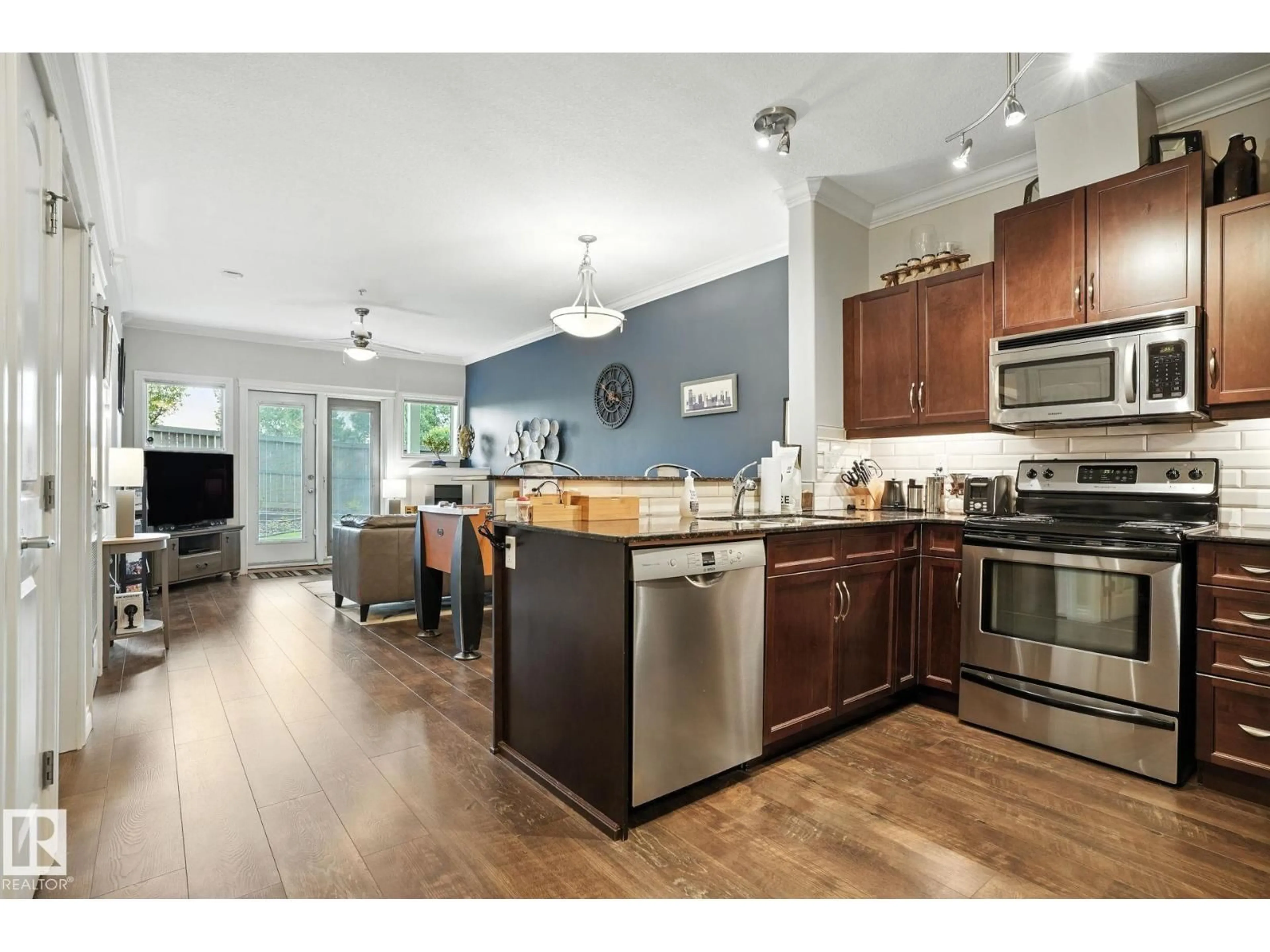 Open concept kitchen, wood/laminate floor for #140 - 10121 80 AV, Edmonton Alberta T6B0E9