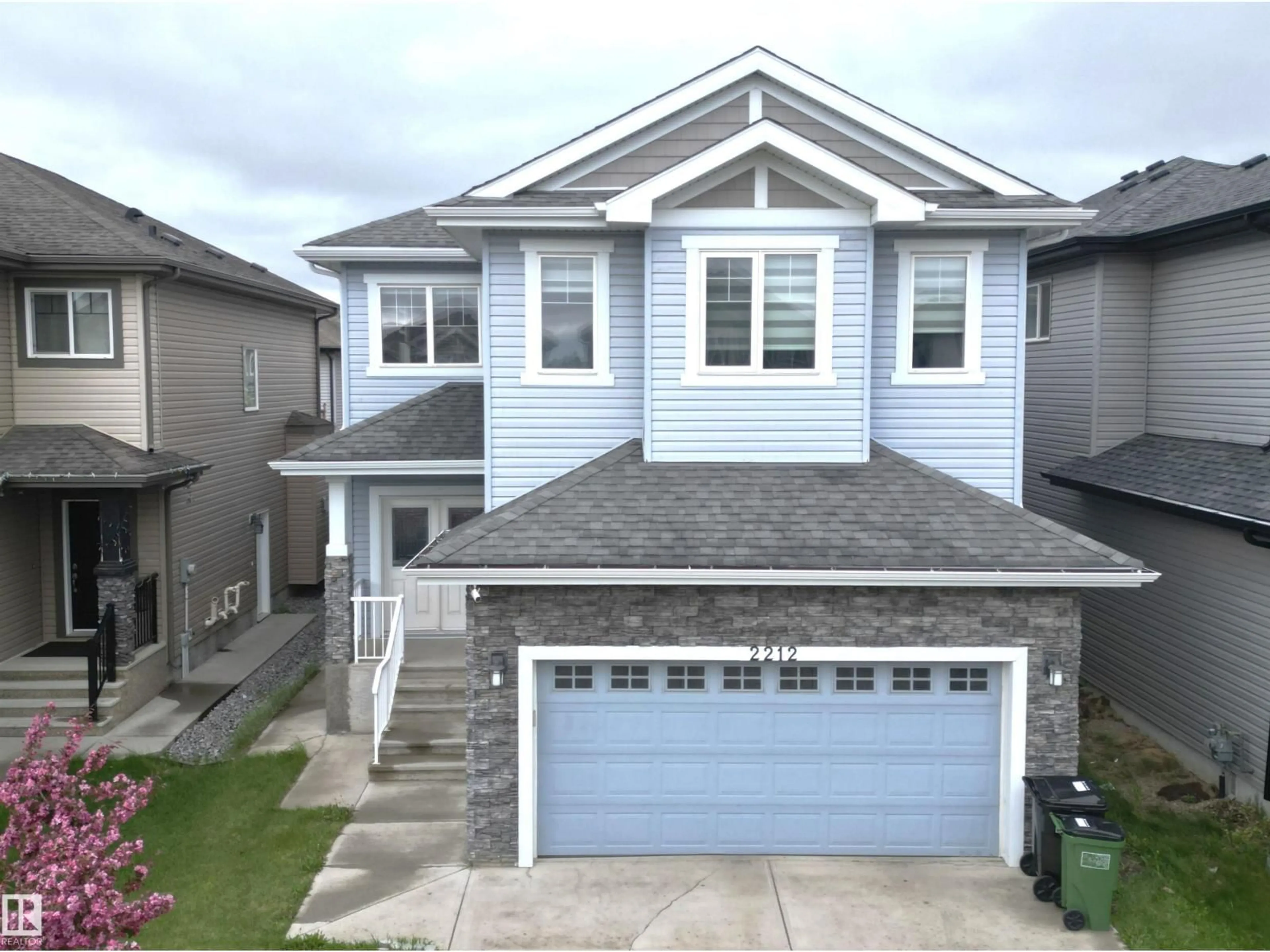 Home with vinyl exterior material, street for 2212 22 ST, Edmonton Alberta T6T0Z1