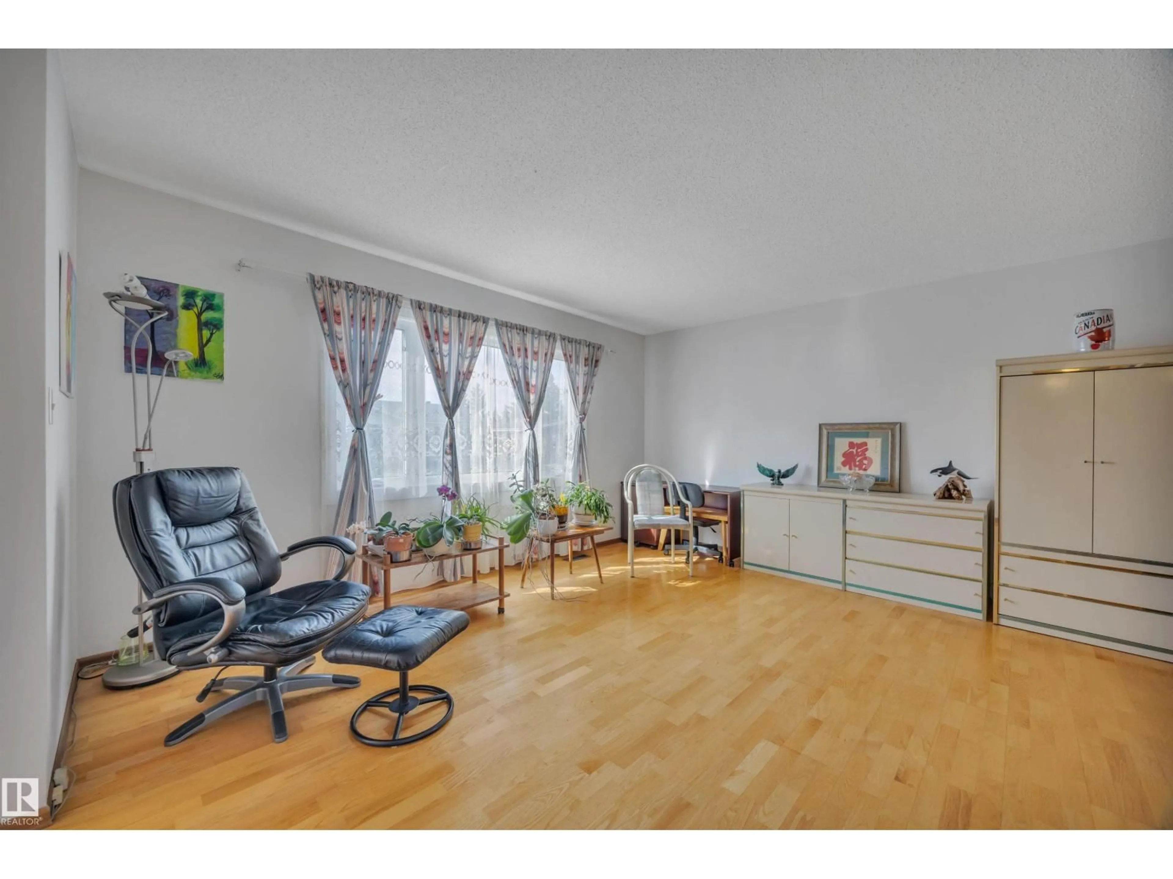 Living room with furniture, wood/laminate floor for NW - 12220 156 AV, Edmonton Alberta T5X2X5