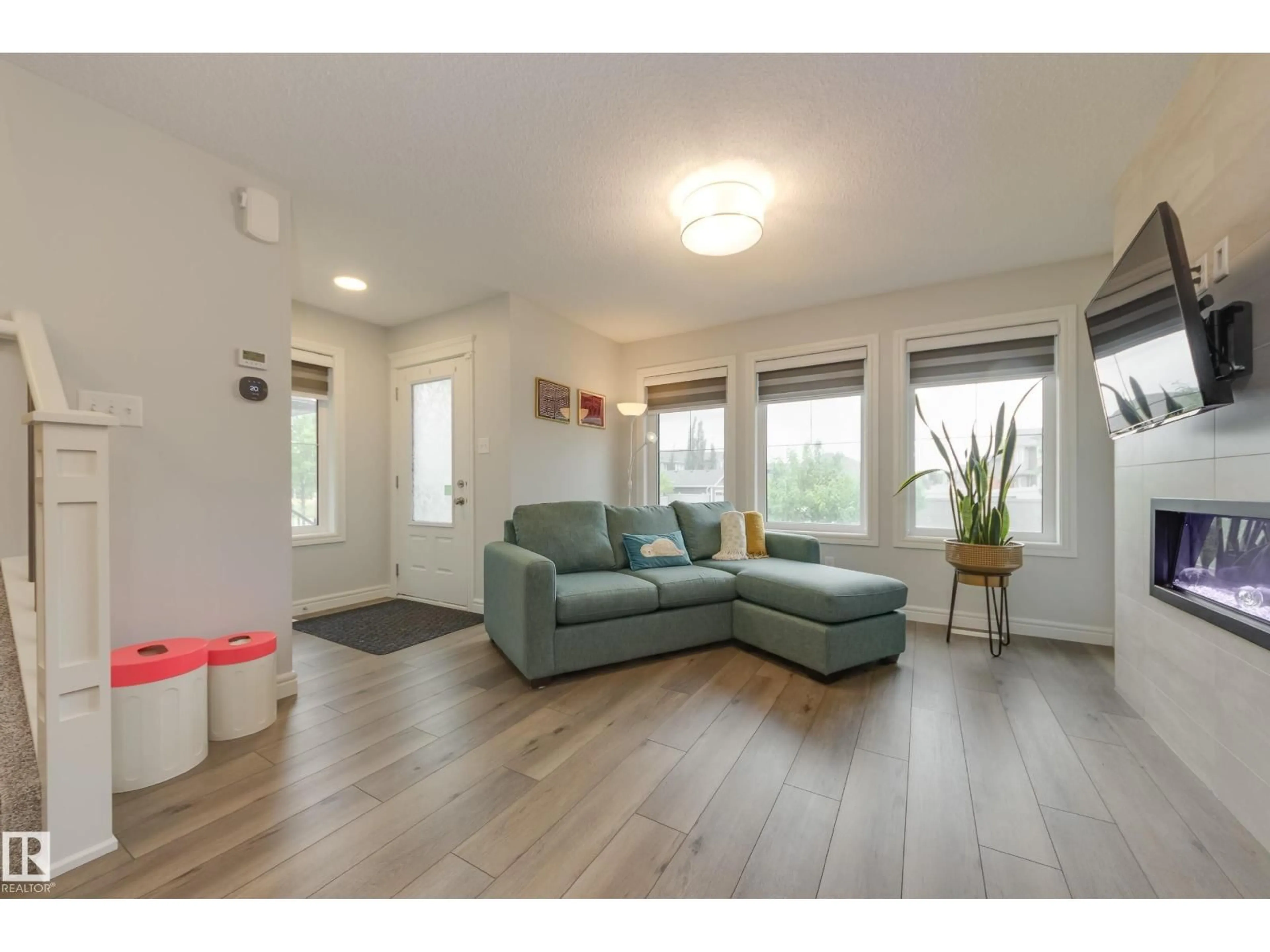 Living room with furniture, wood/laminate floor for 5646 JUCHLI AV, Edmonton Alberta T5E6X5