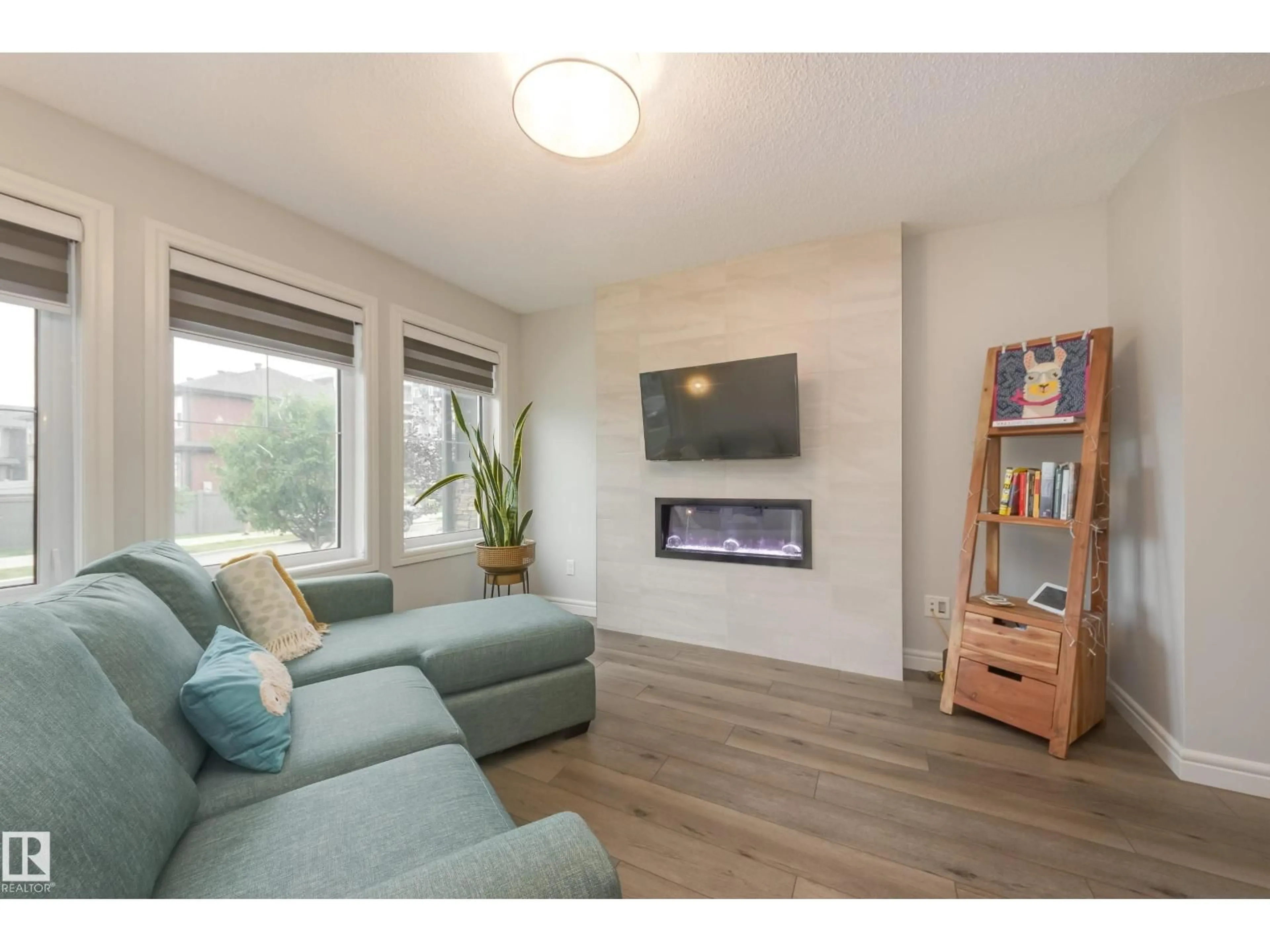 Living room with furniture, wood/laminate floor for 5646 JUCHLI AV, Edmonton Alberta T5E6X5