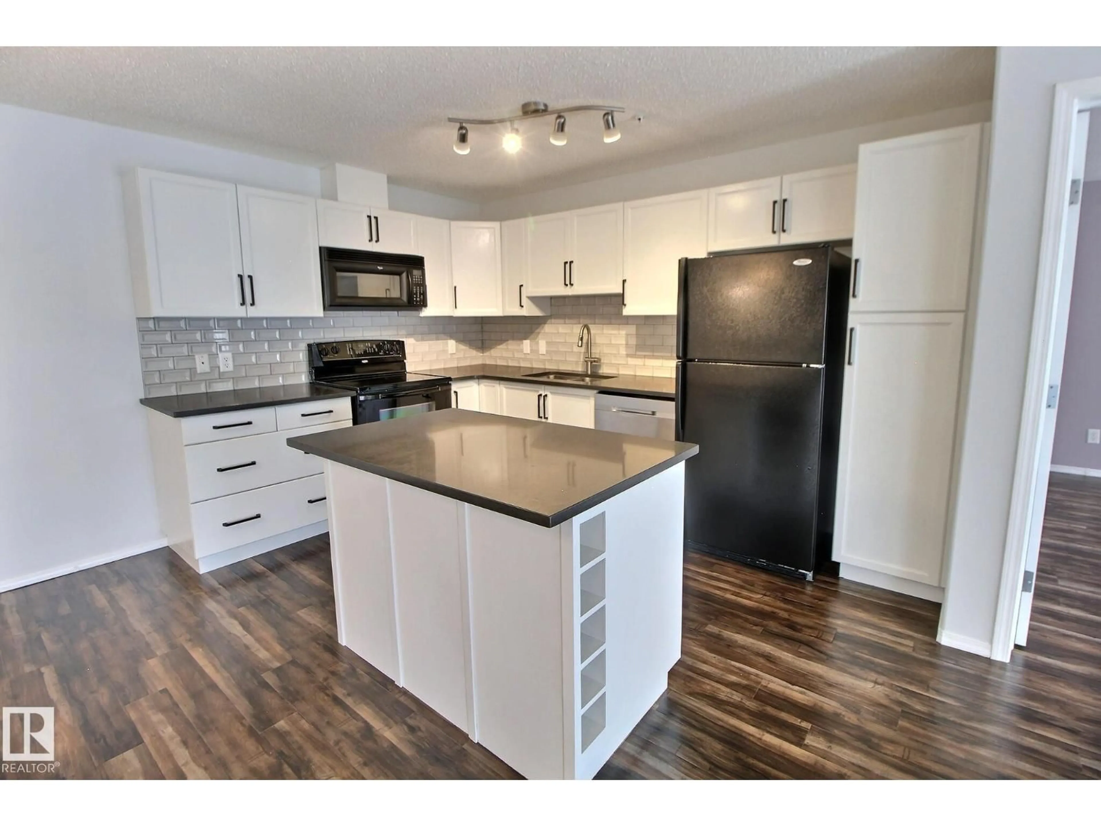 Open concept kitchen, wood/laminate floor for 228 16035 132 ST NW, Edmonton Alberta T6V0B4