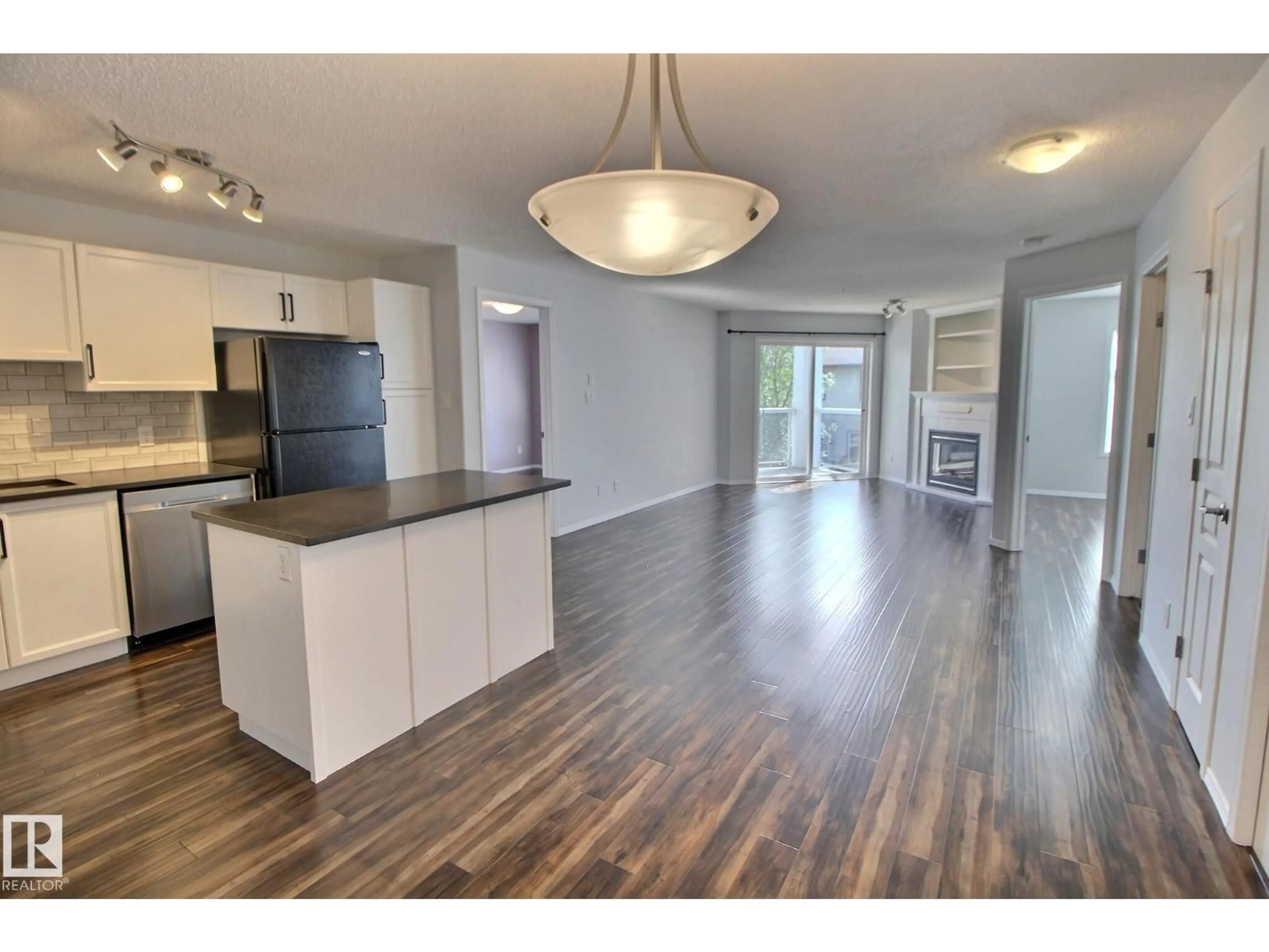 Open concept kitchen, wood/laminate floor for 228 16035 132 ST NW, Edmonton Alberta T6V0B4