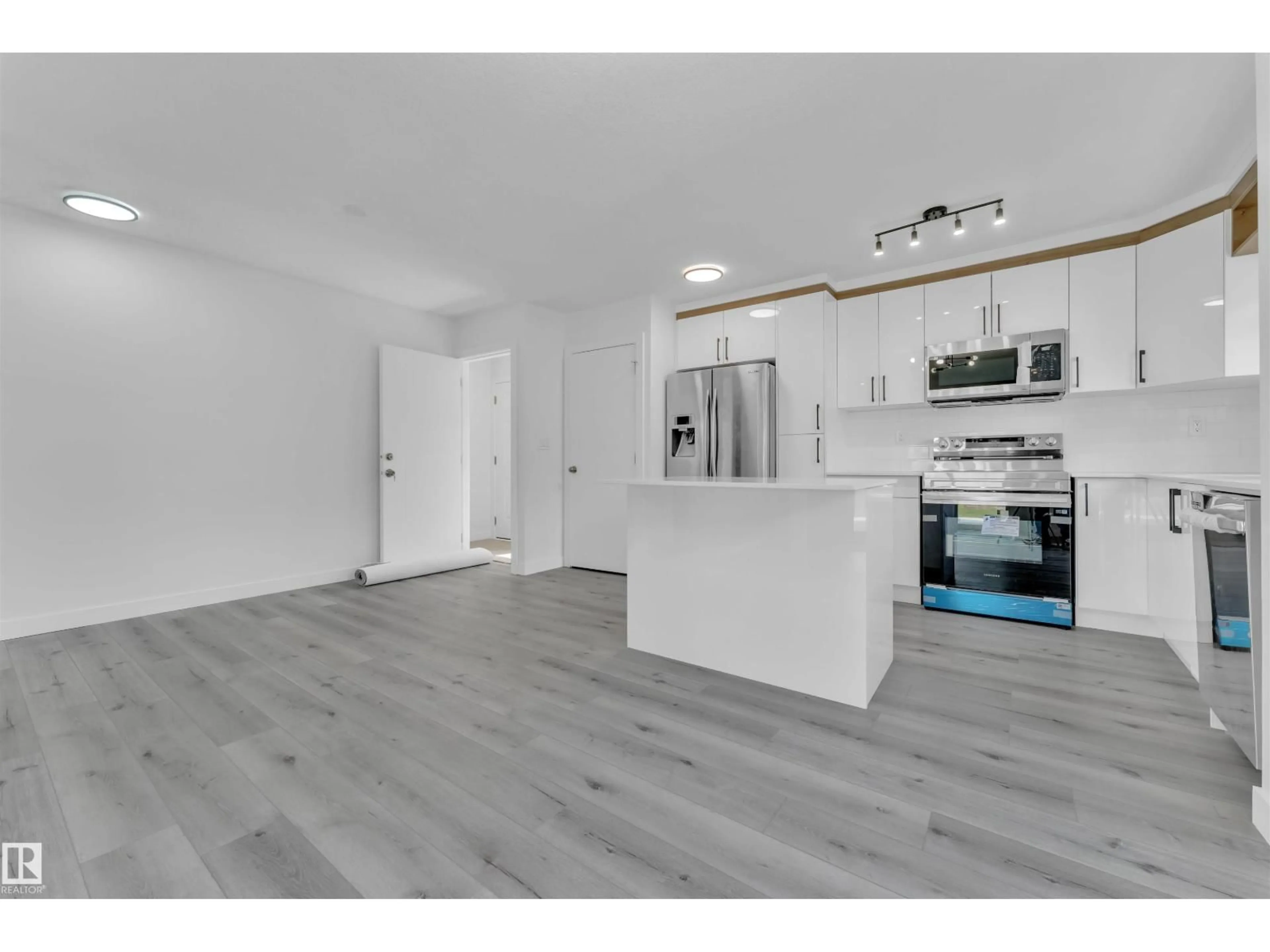 Open concept kitchen, wood/laminate floor for 3816 17B AV NW, Edmonton Alberta T6L3B9