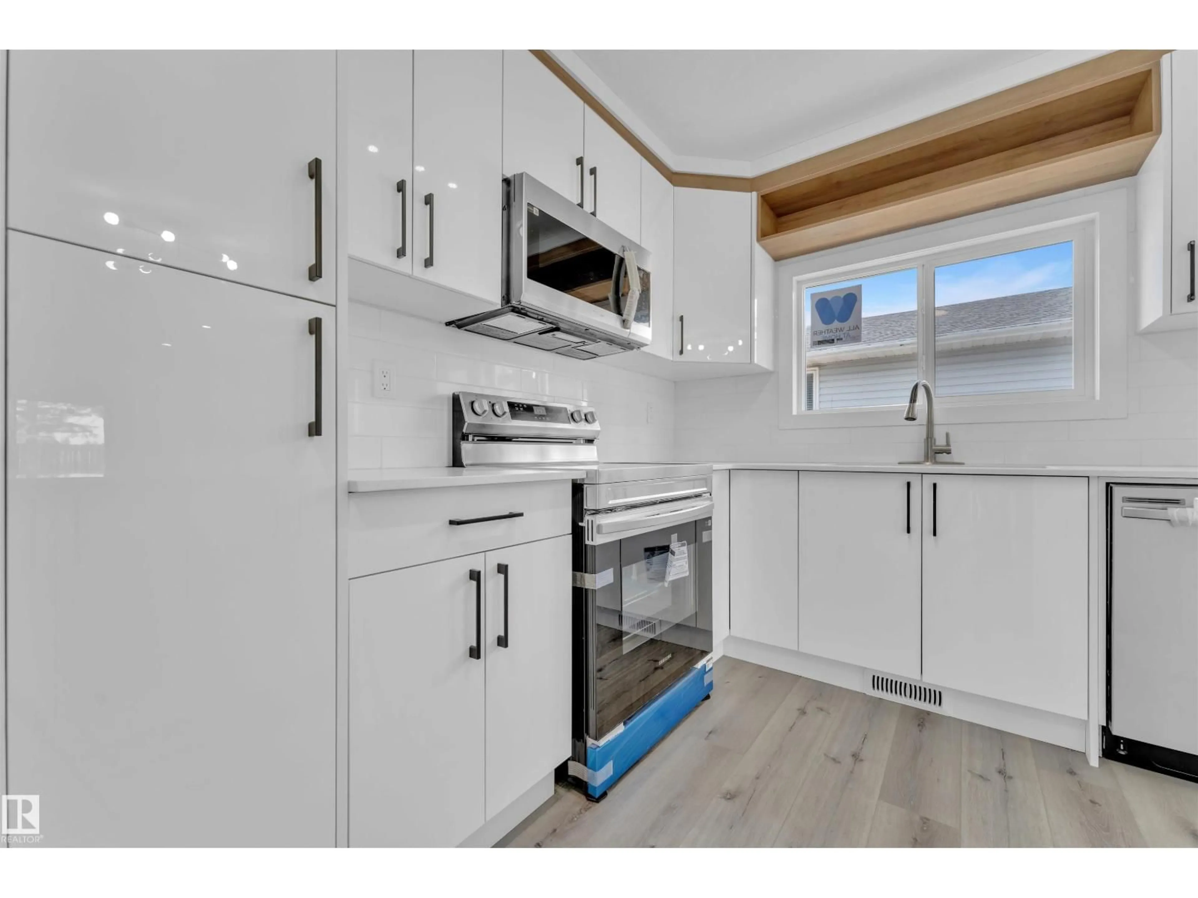 Open concept kitchen, wood/laminate floor for 3816 17B AV NW, Edmonton Alberta T6L3B9