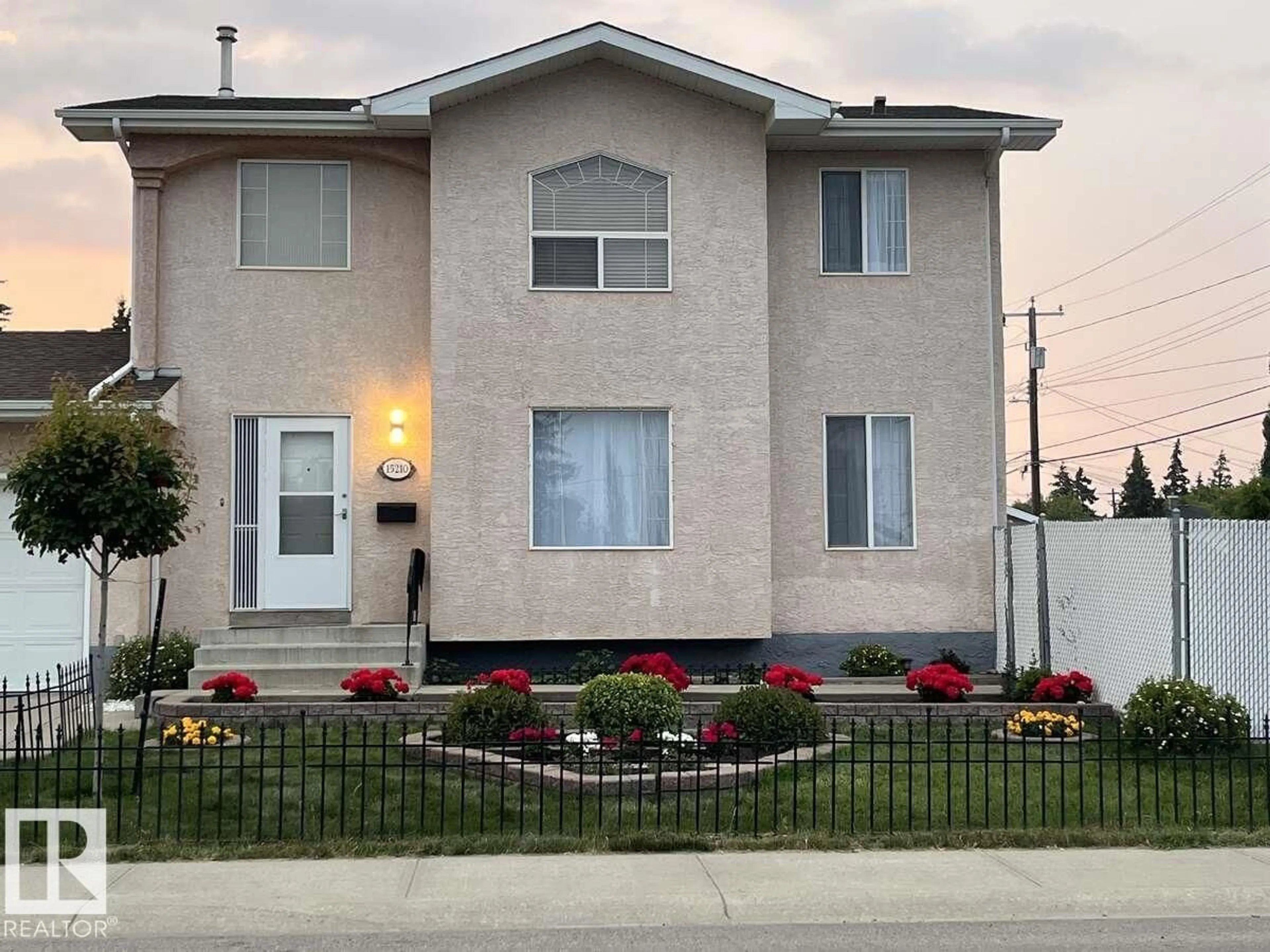 Home with vinyl exterior material, street for 15210 103 AV, Edmonton Alberta T5P4T7
