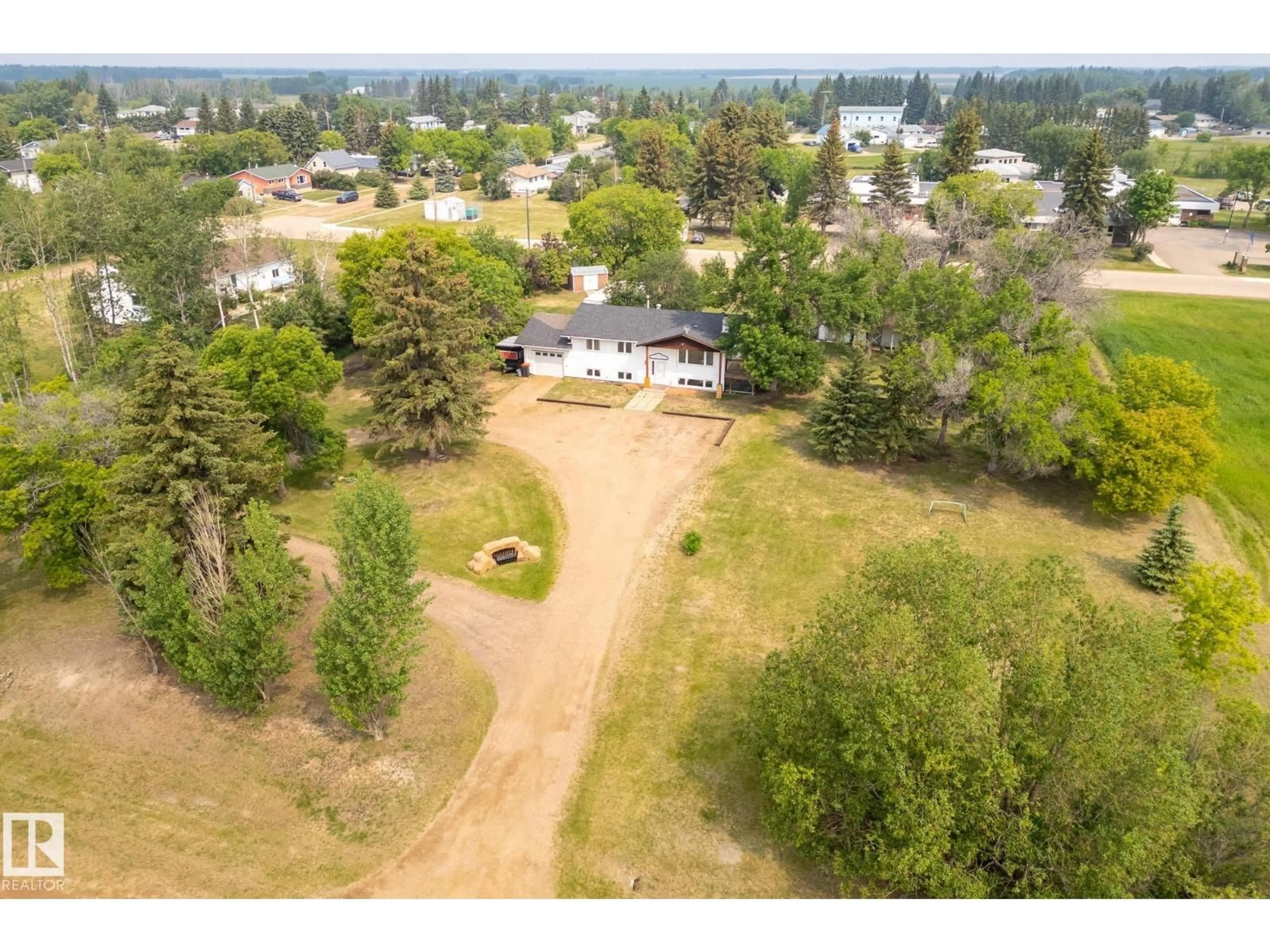 A pic from outside/outdoor area/front of a property/back of a property/a pic from drone, water/lake/river/ocean view for 320 1 AV, Thorhild Alberta T0A3J0