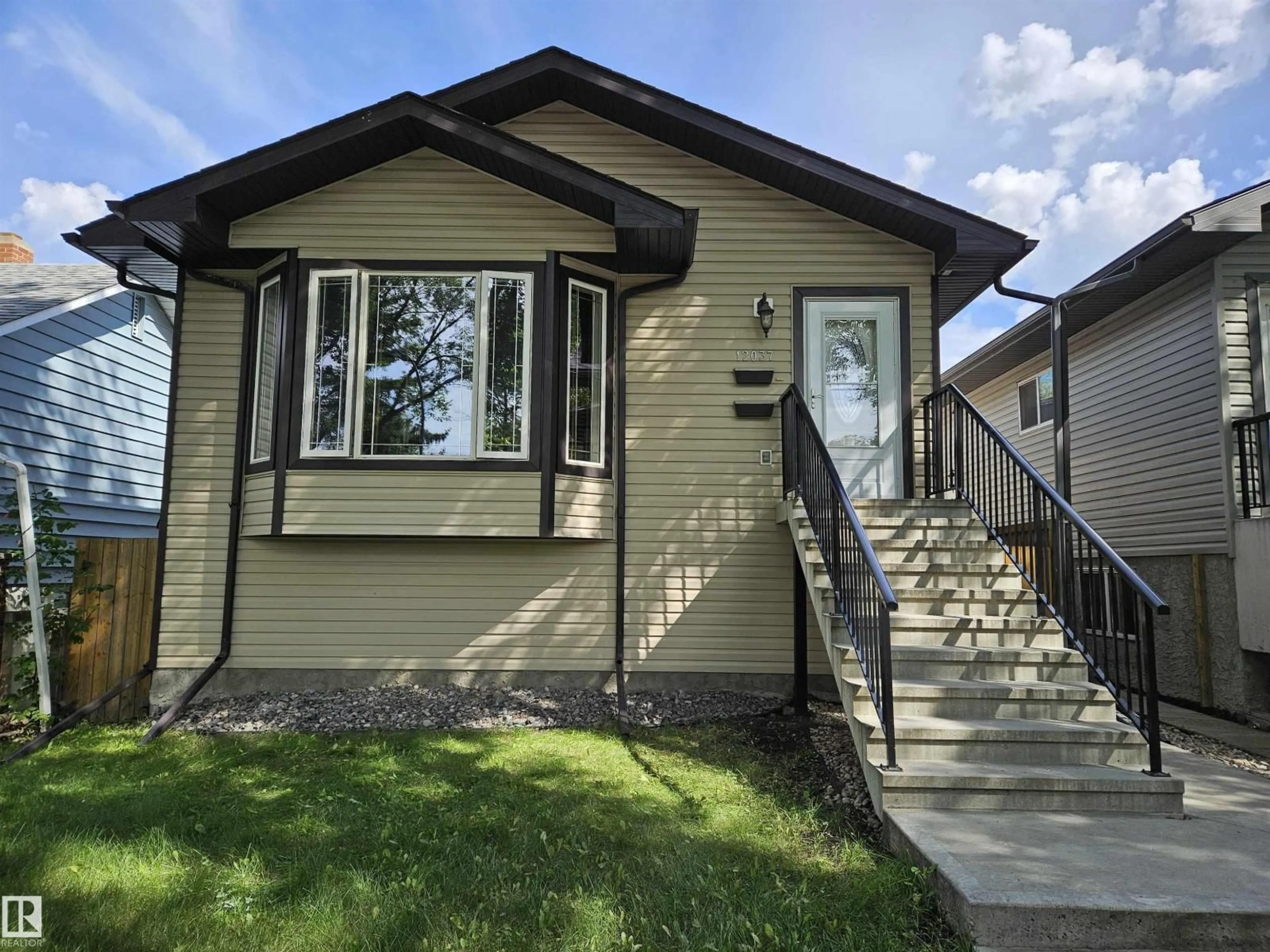 Home with vinyl exterior material, street for NW - 12037 58 ST, Edmonton Alberta T5W3X2