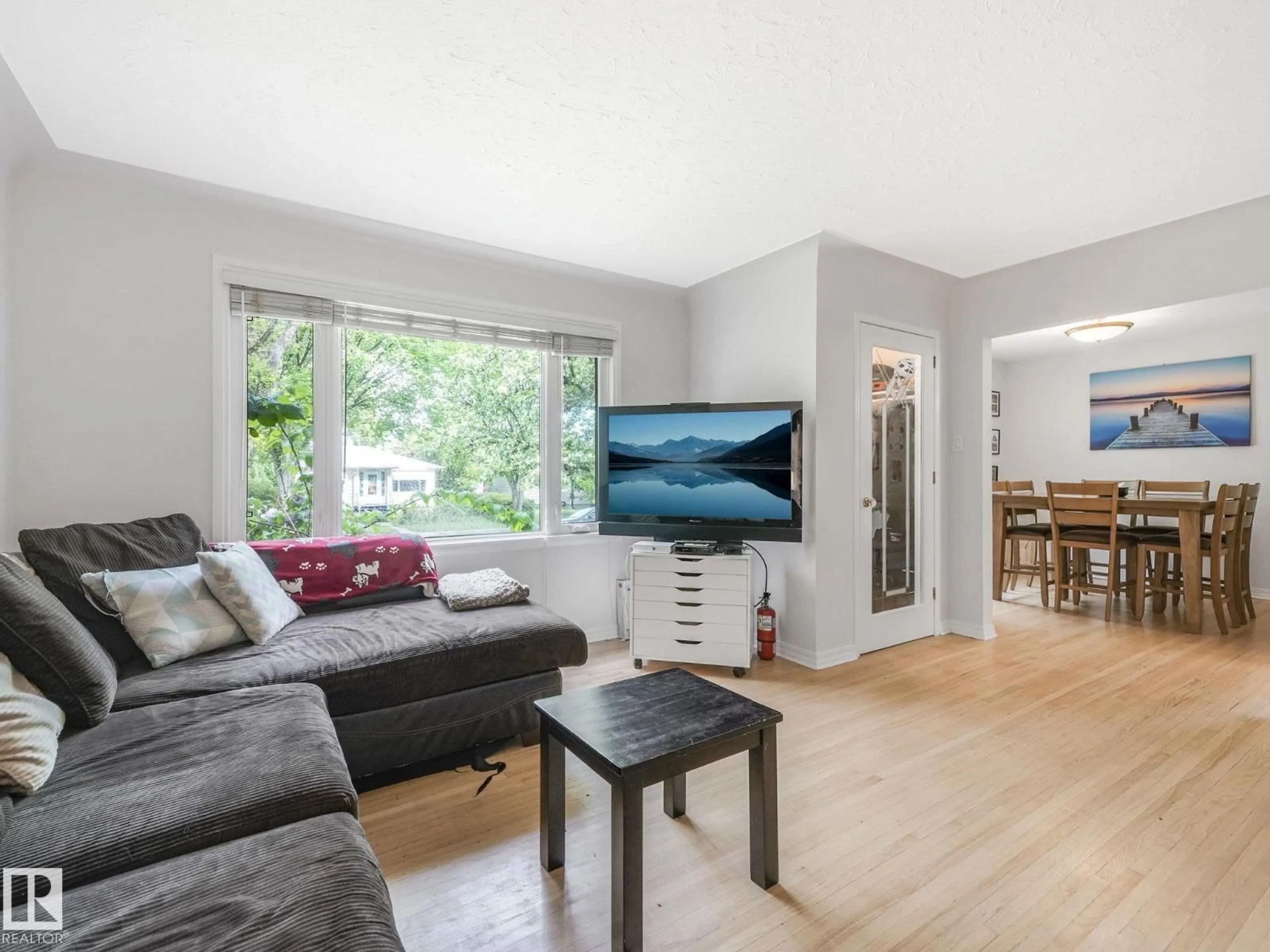 Living room with furniture, wood/laminate floor for 11514 122 ST, Edmonton Alberta T5M0C1