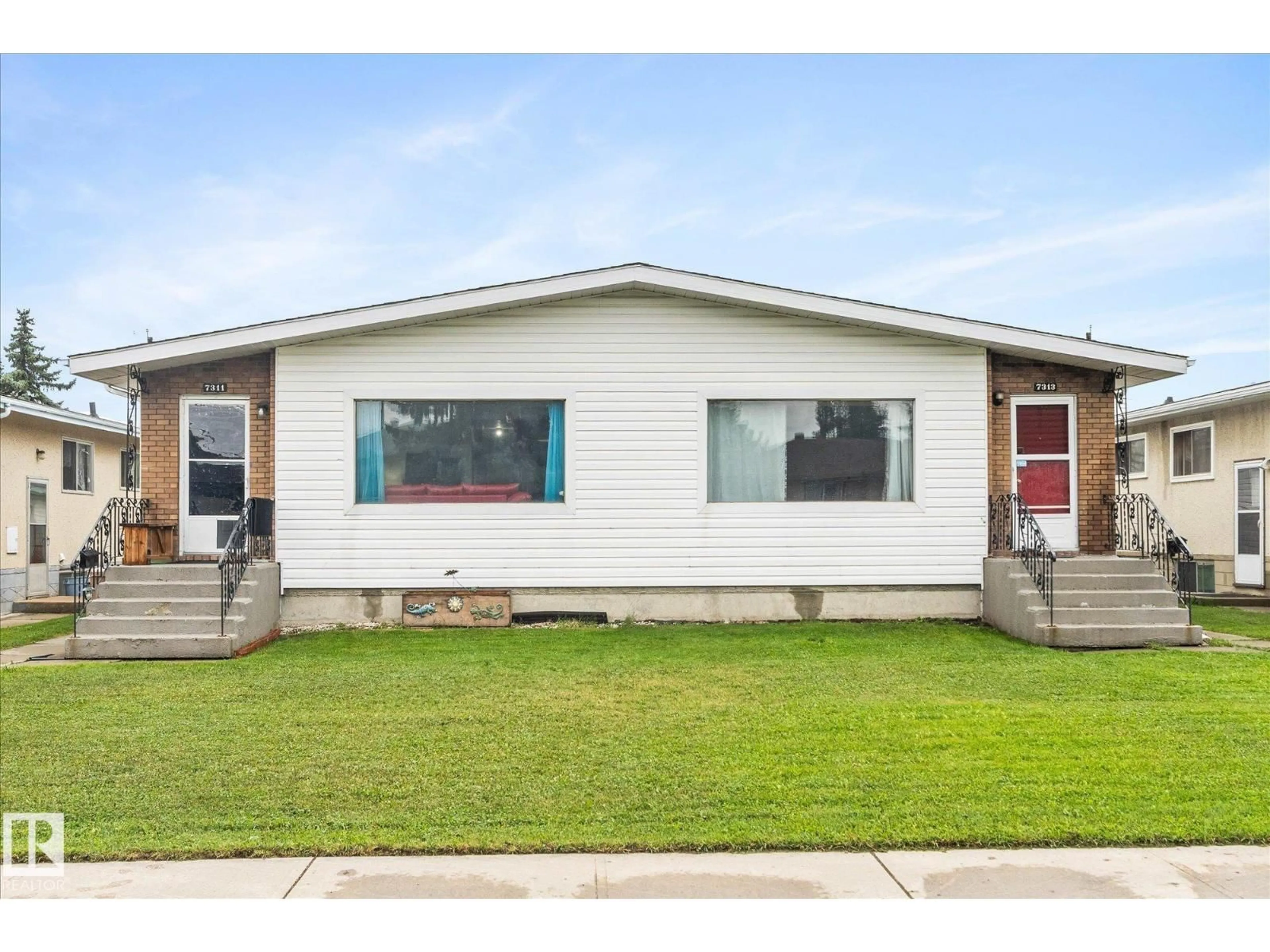 Home with vinyl exterior material, street for 7311/7313 79 AV, Edmonton Alberta T6B0C4