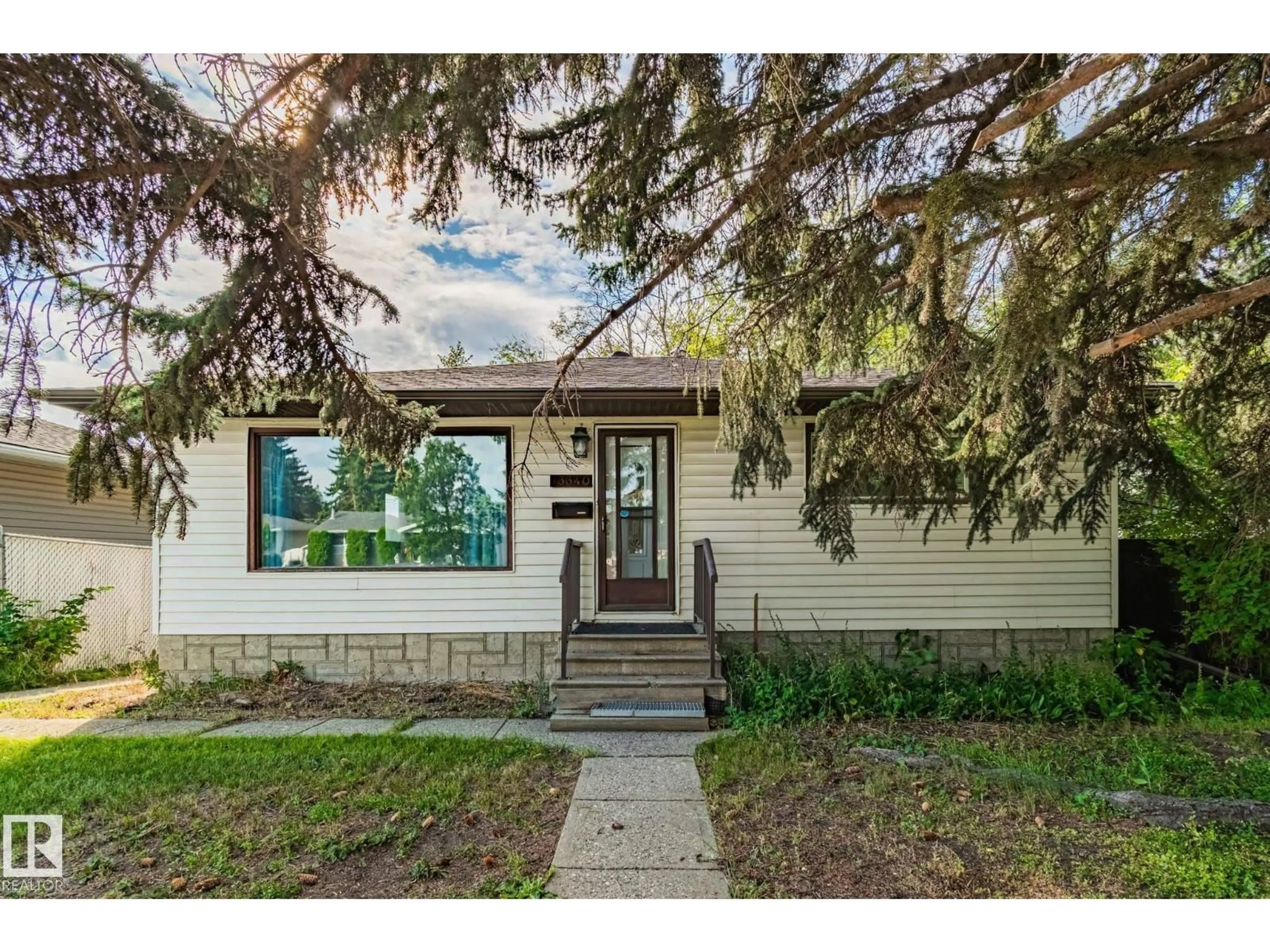 Home with vinyl exterior material, street for 13340 123 ST, Edmonton Alberta T5L0J9