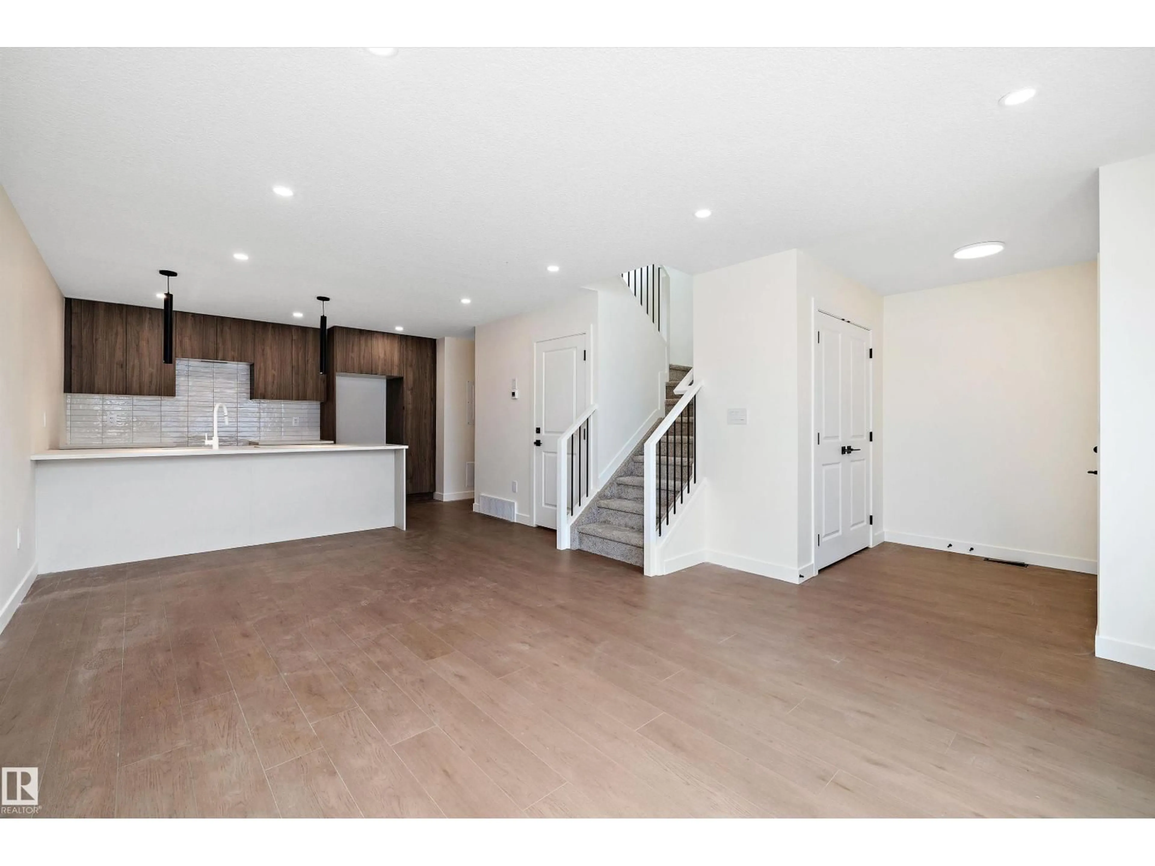 Open concept kitchen, wood/laminate floor for 11738 91 ST, Edmonton Alberta T5B4B3
