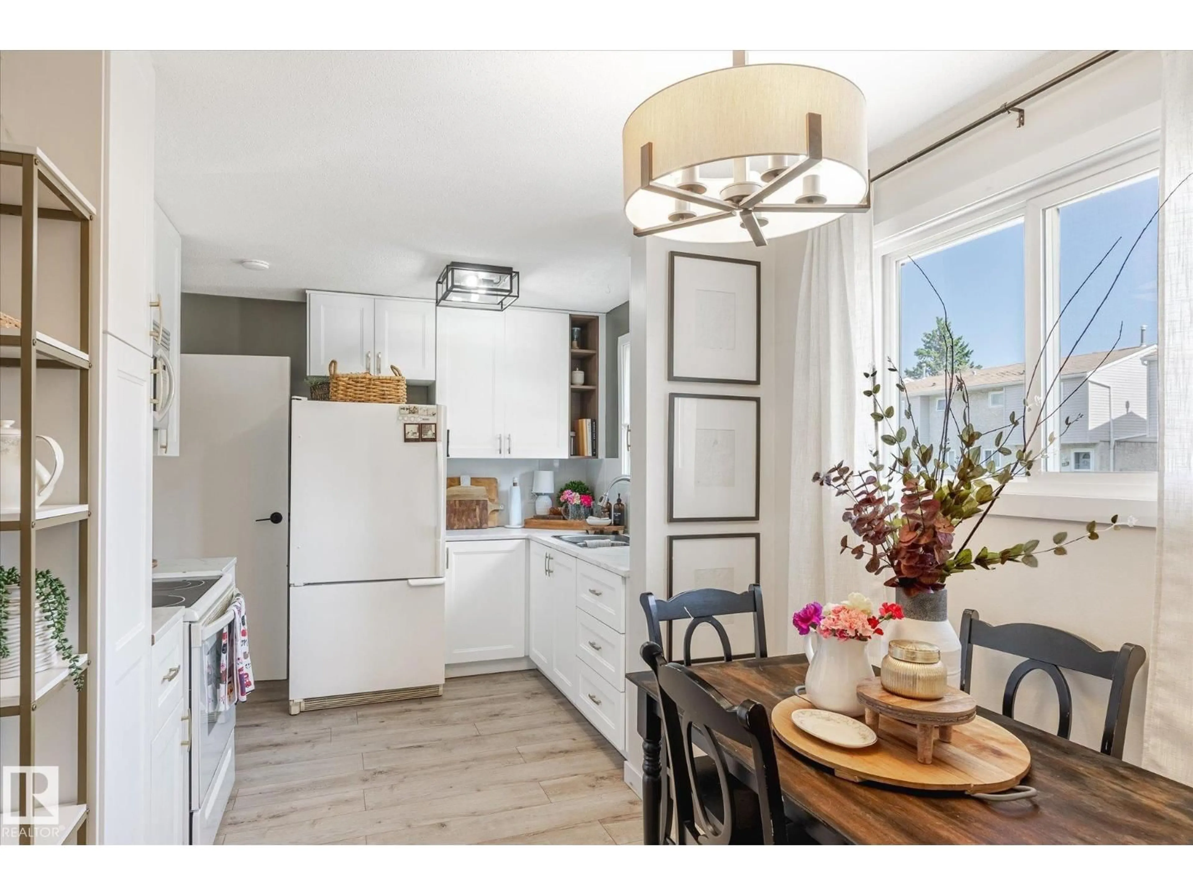 Open concept kitchen, wood/laminate floor for #109 - 5231 51 ST, Bon Accord Alberta T0A0K0
