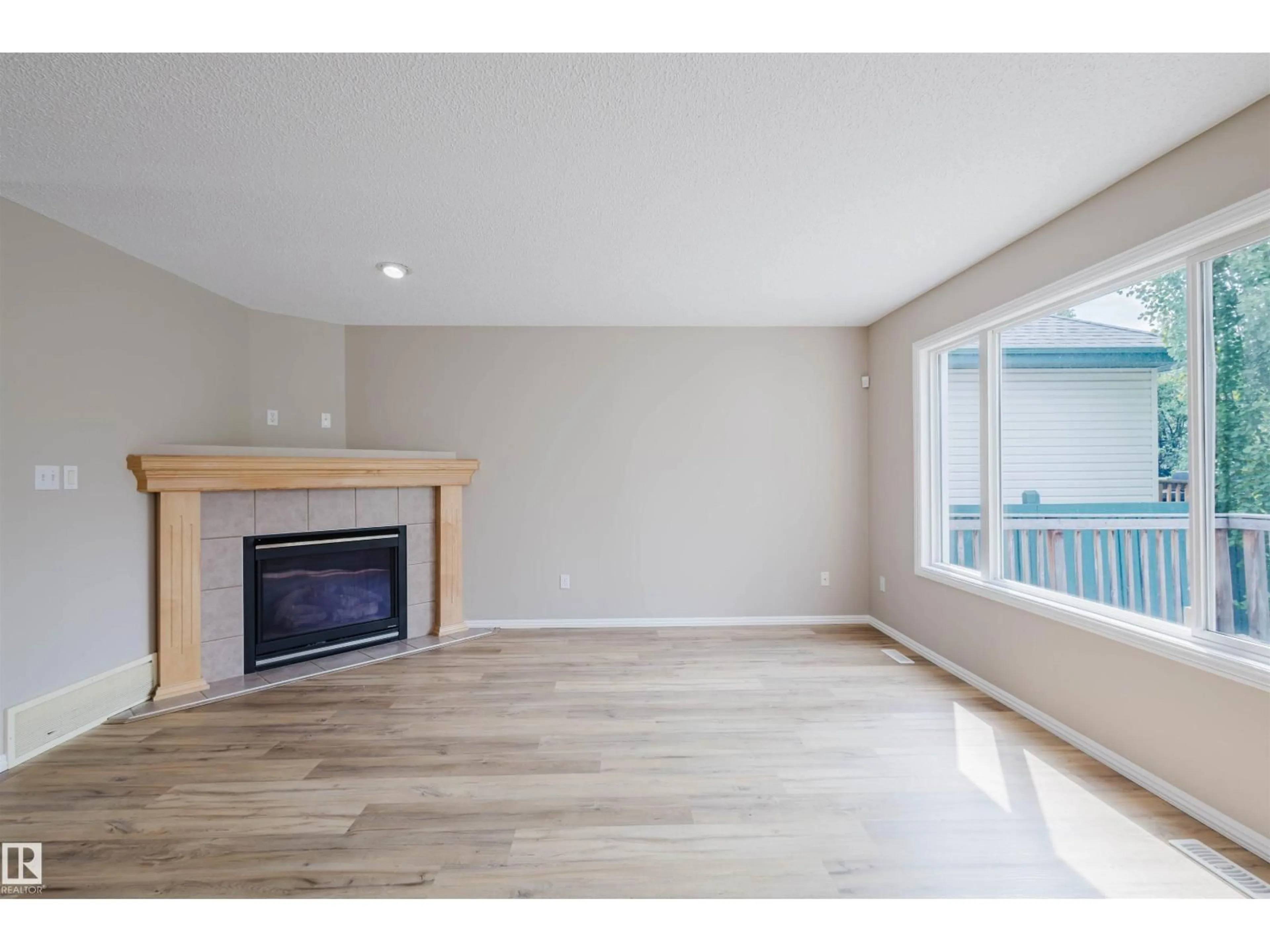 Living room with furniture, wood/laminate floor for 2611 HANNA CR, Edmonton Alberta T6R3C9