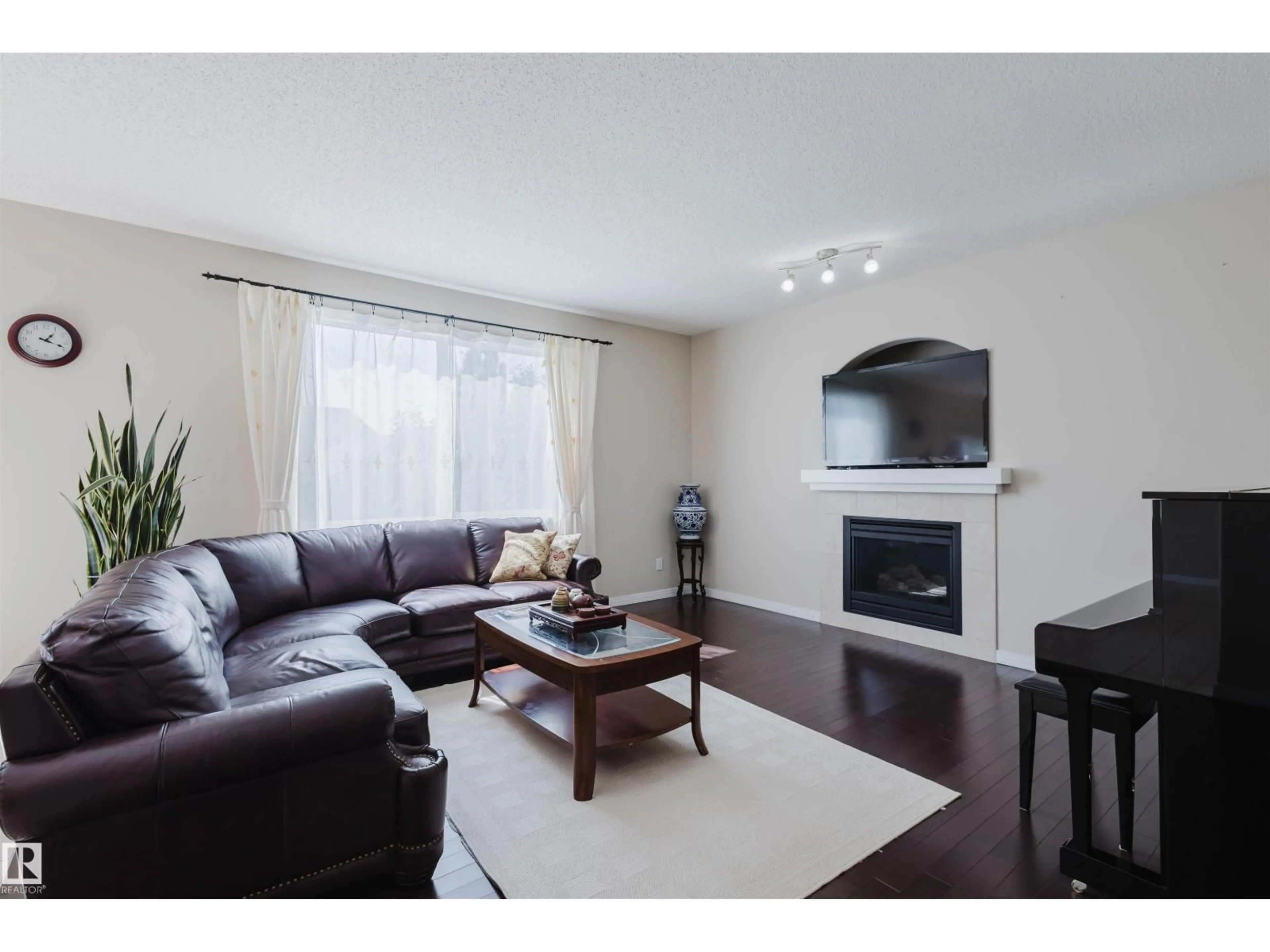 Living room with furniture, wood/laminate floor for 6731 SPEAKER PL, Edmonton Alberta T6R0N9