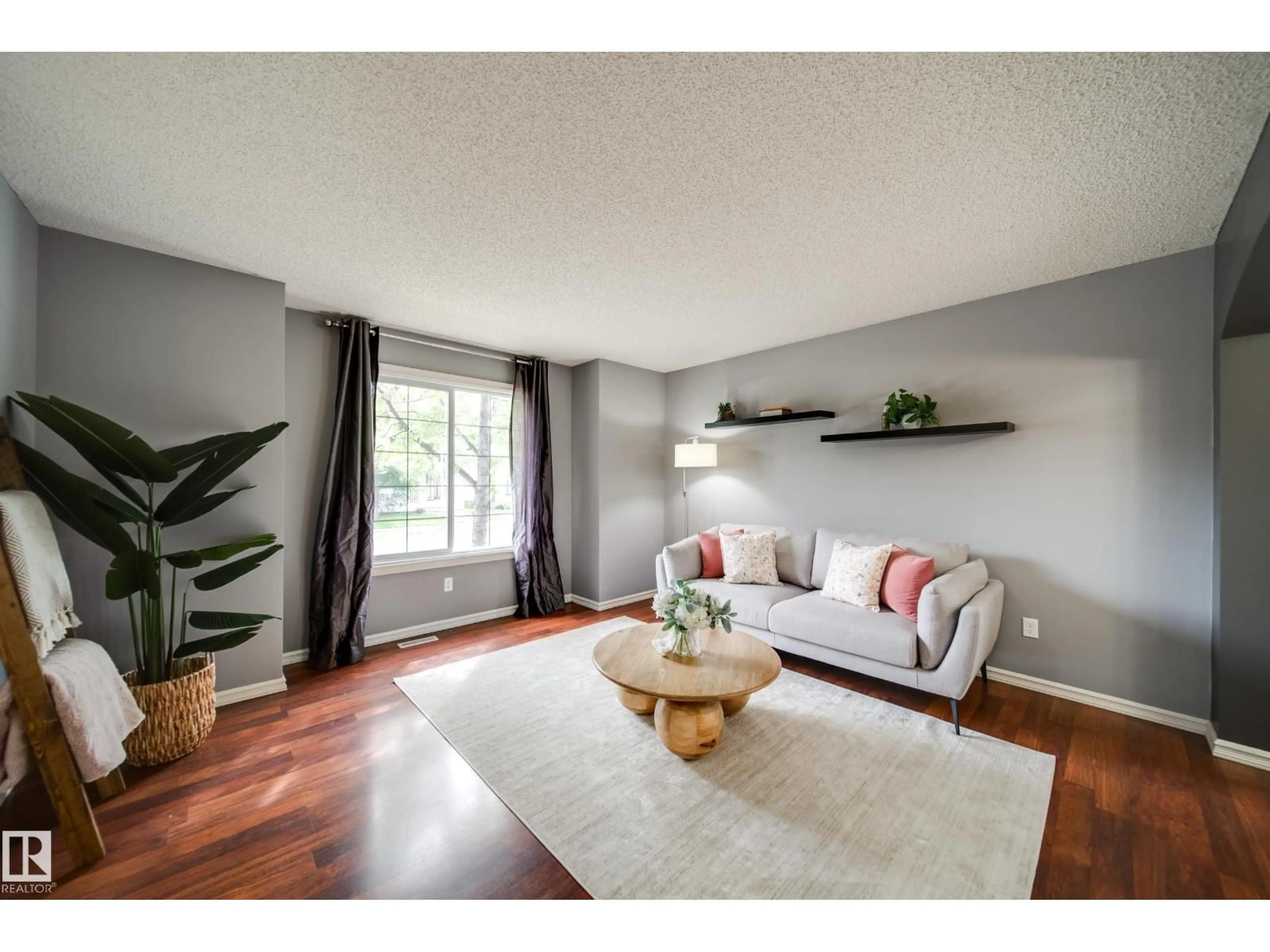 Living room with furniture, wood/laminate floor for NW - 16318 57 ST, Edmonton Alberta T5Y0A1