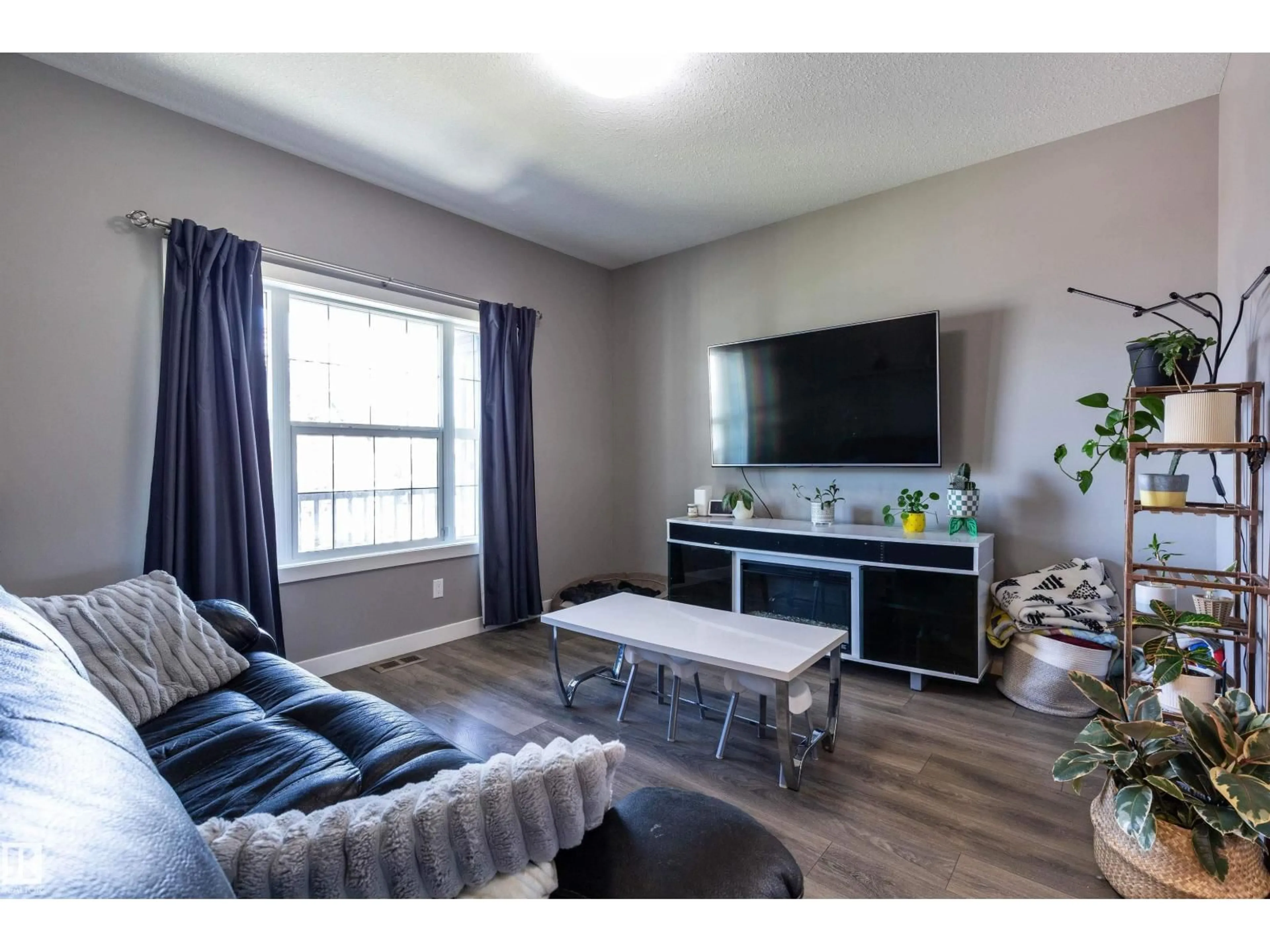 Living room with furniture, wood/laminate floor for 17804 59 ST, Edmonton Alberta T5Y0W8