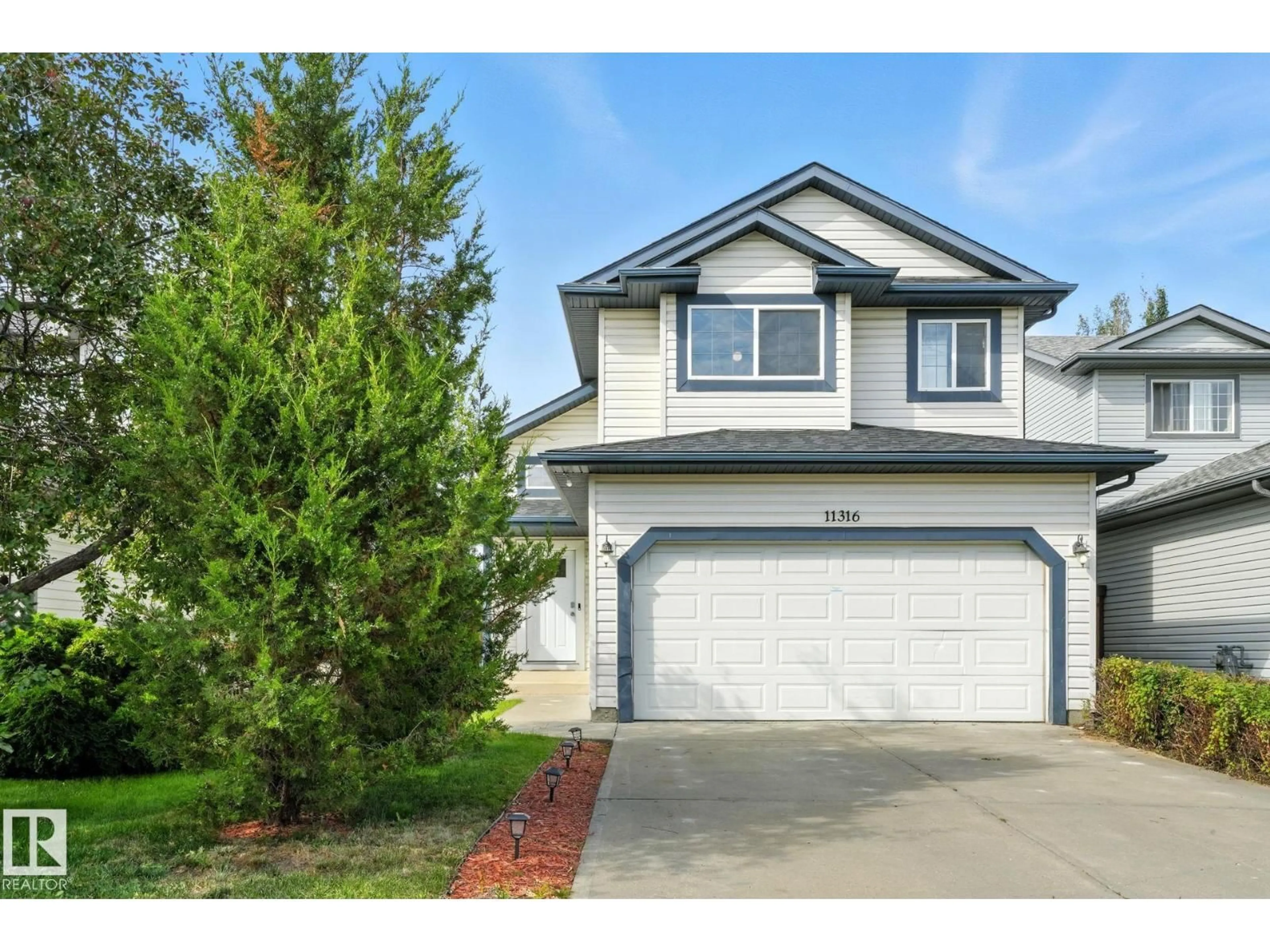 Home with vinyl exterior material, street for NW - 11316 167B AV, Edmonton Alberta T5X6G8