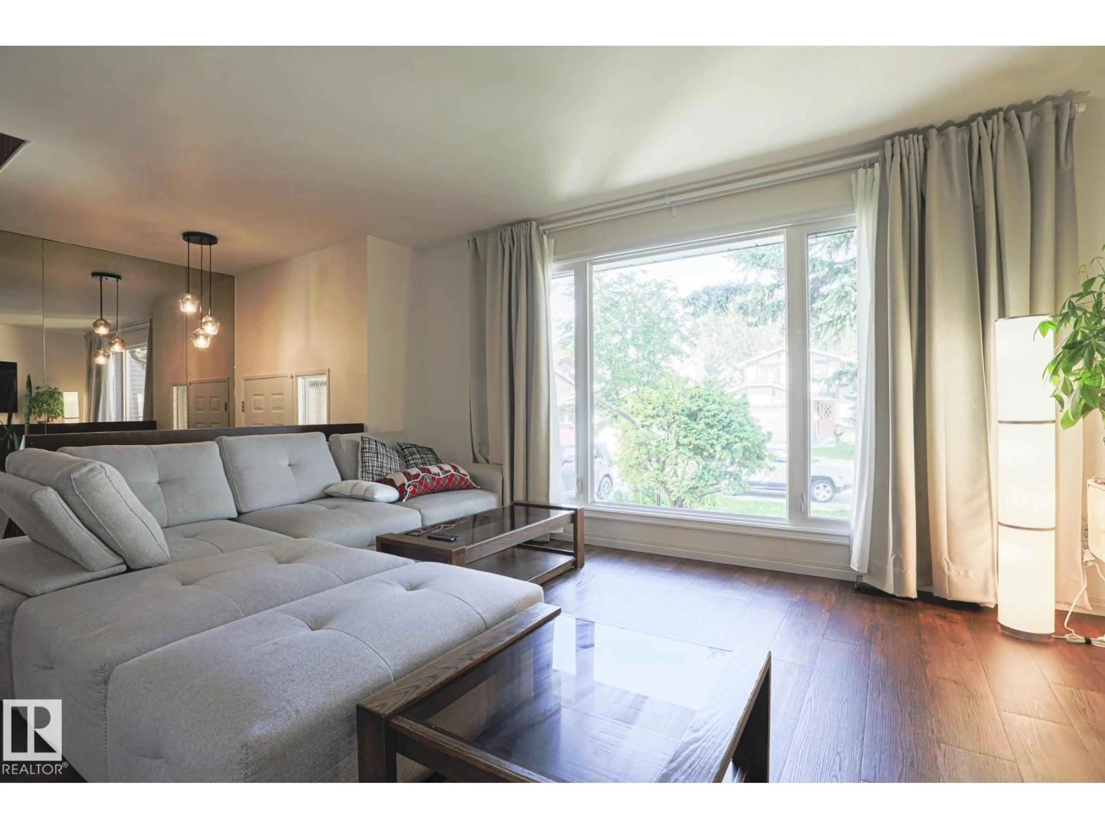 Living room with furniture, wood/laminate floor for NW - 7608 181 ST, Edmonton Alberta T5T1Z7