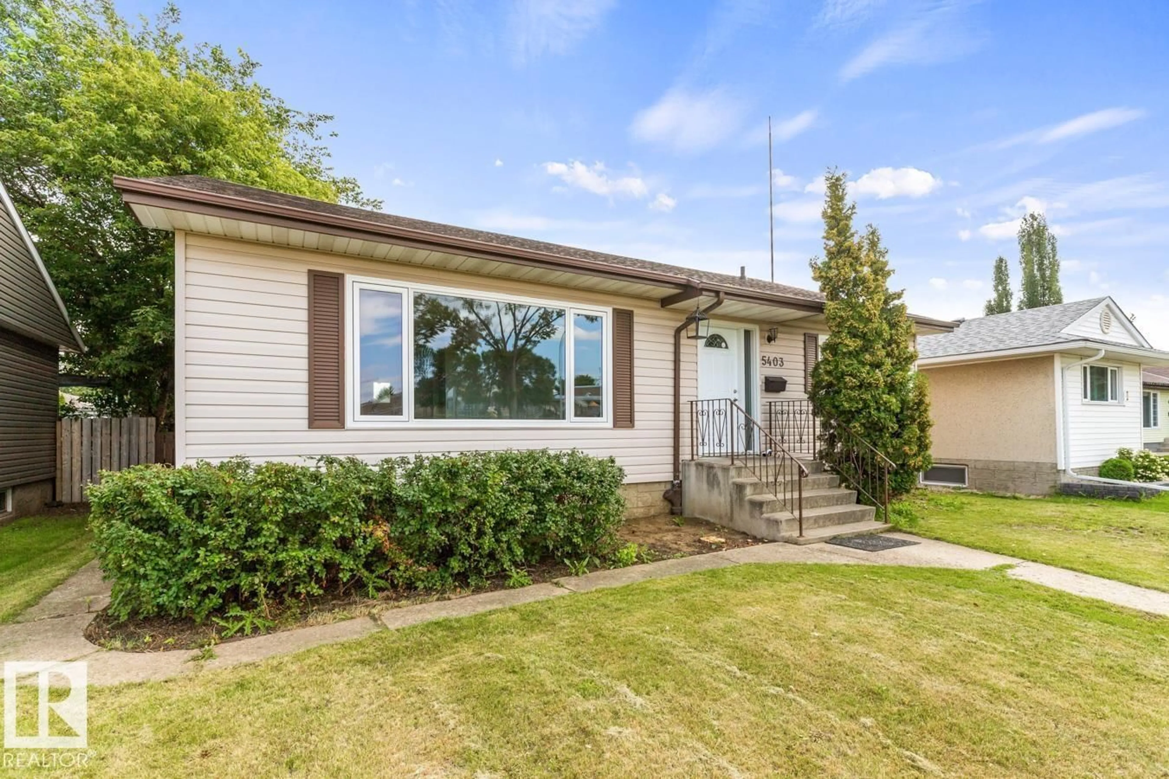 Home with vinyl exterior material, street for 5403 106 AV, Edmonton Alberta T6A1G1