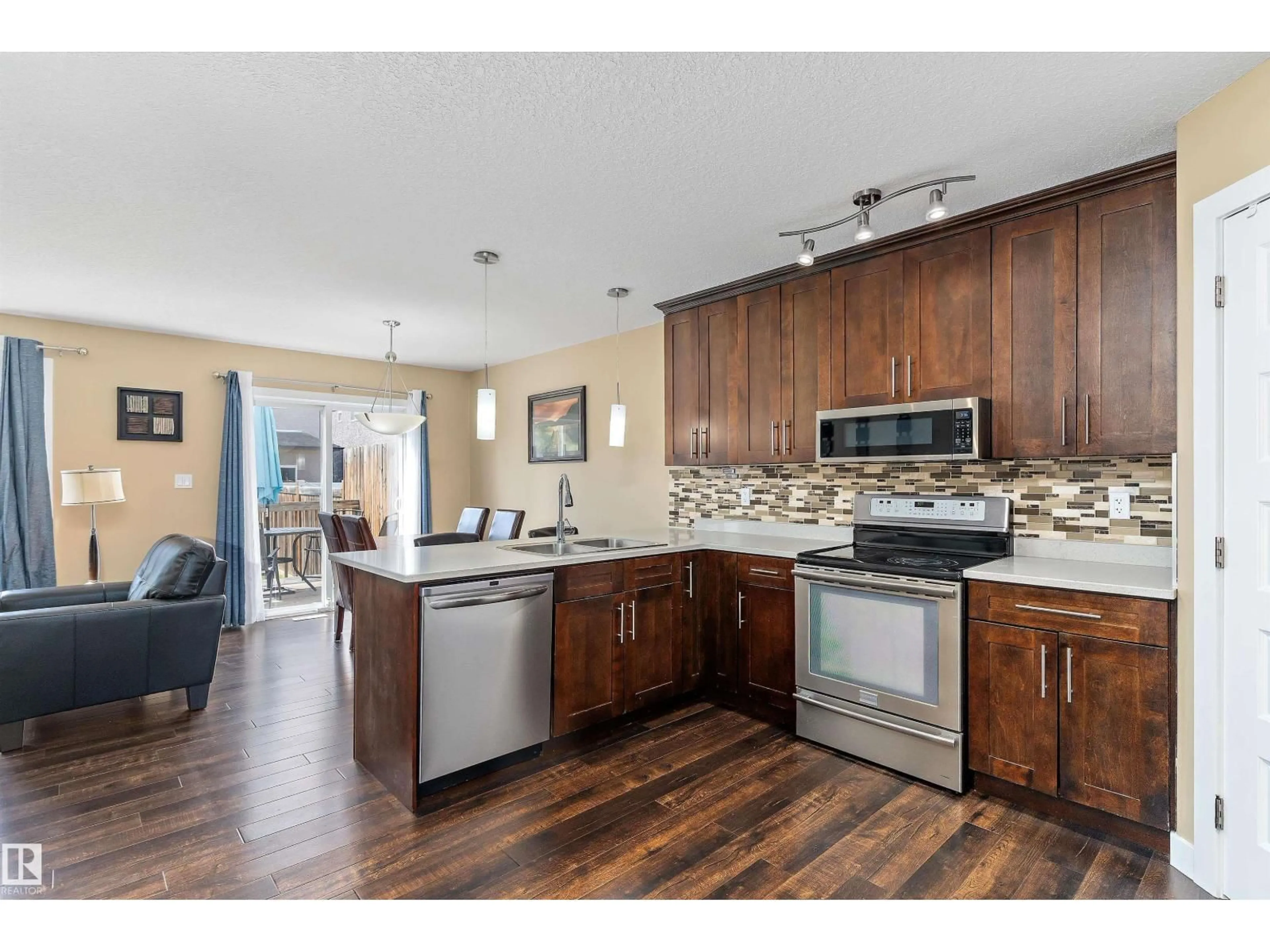 Open concept kitchen, wood/laminate floor for NW - 15132 31 ST, Edmonton Alberta T5Y0S3