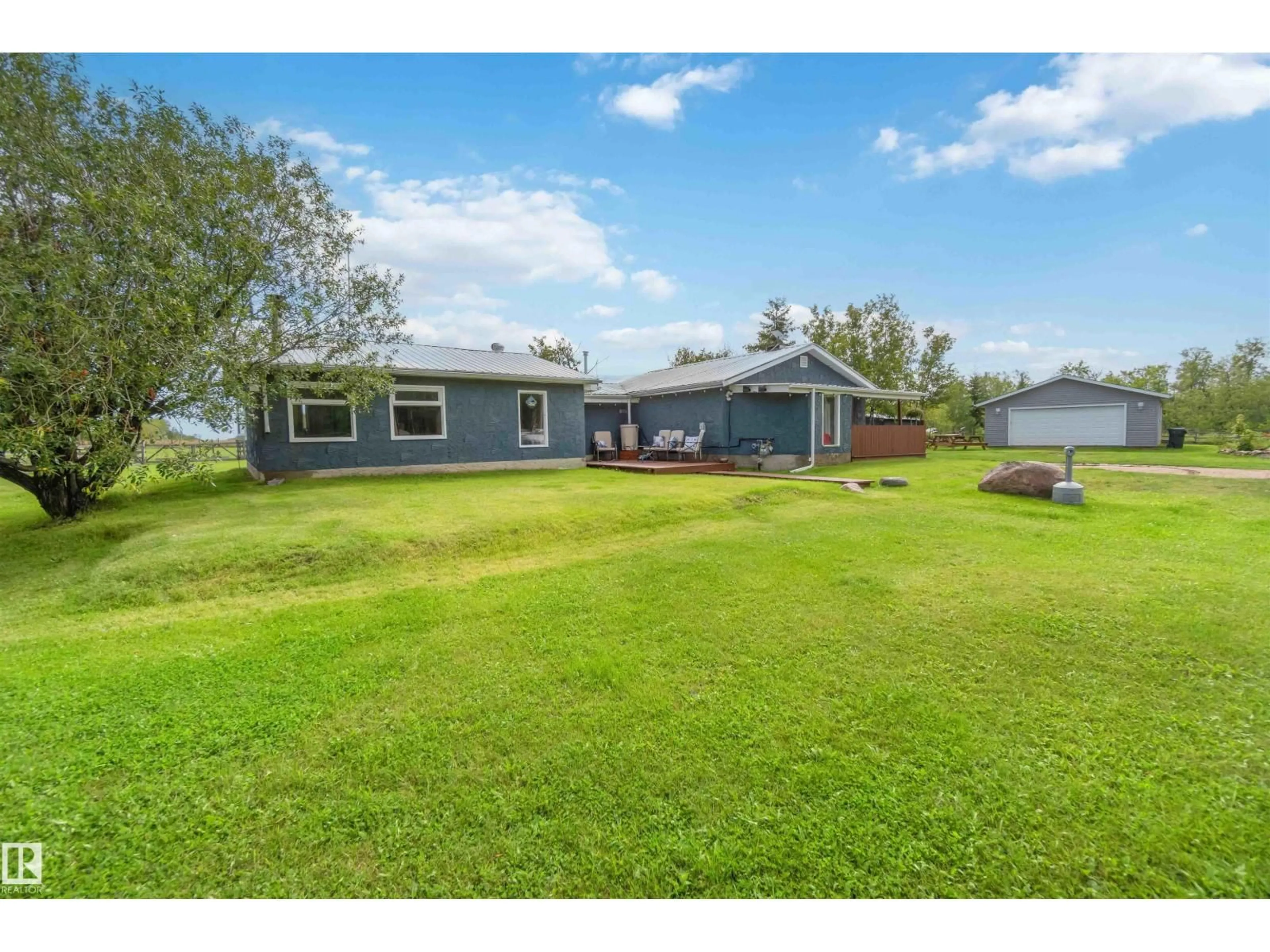 A pic from outside/outdoor area/front of a property/back of a property/a pic from drone, water/lake/river/ocean view for 19 - 23422 TWP RD 582, Rural Sturgeon County Alberta T0G1L2
