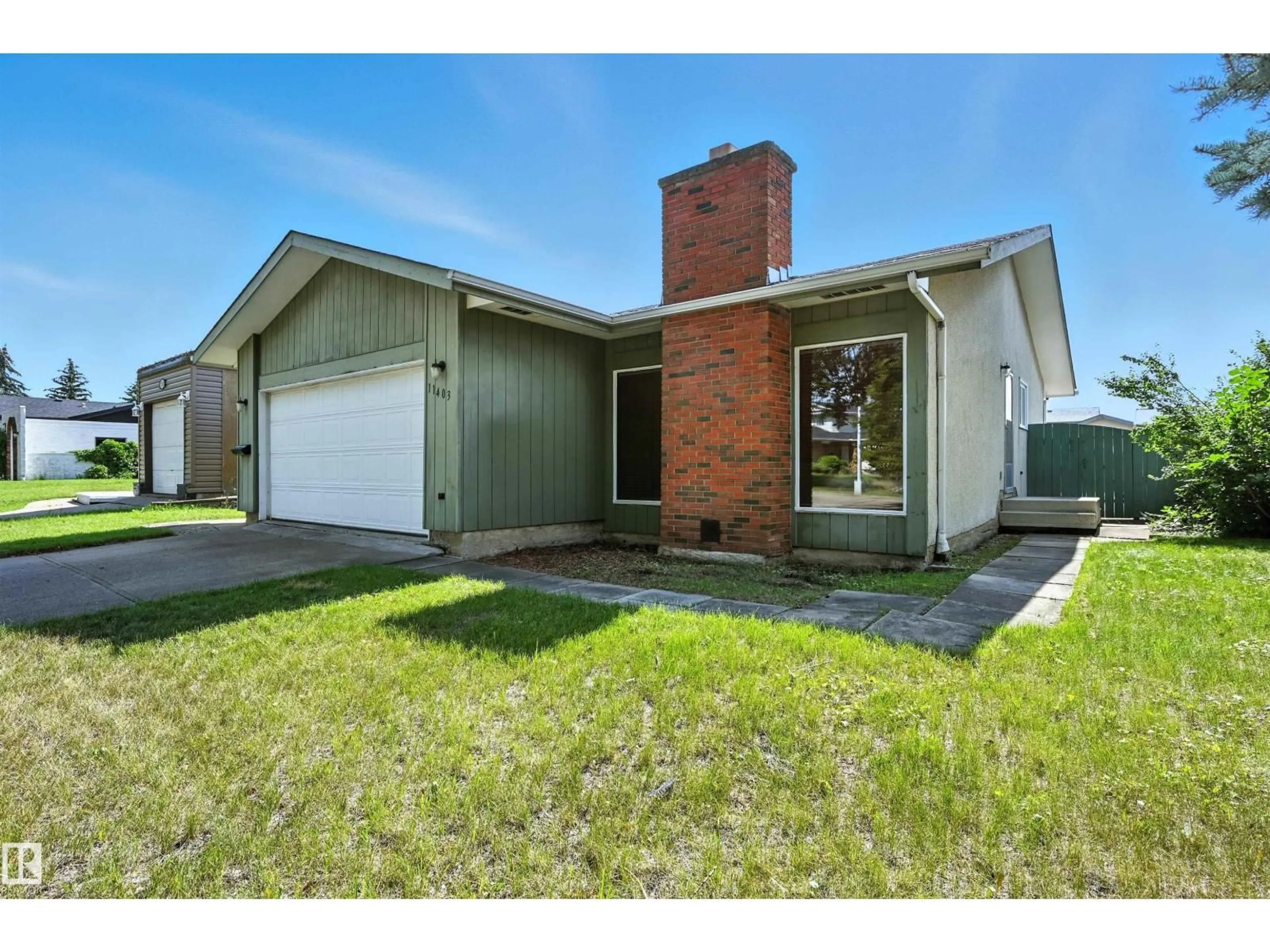 Home with brick exterior material, street for 11403 145 AV, Edmonton Alberta T5X1L9