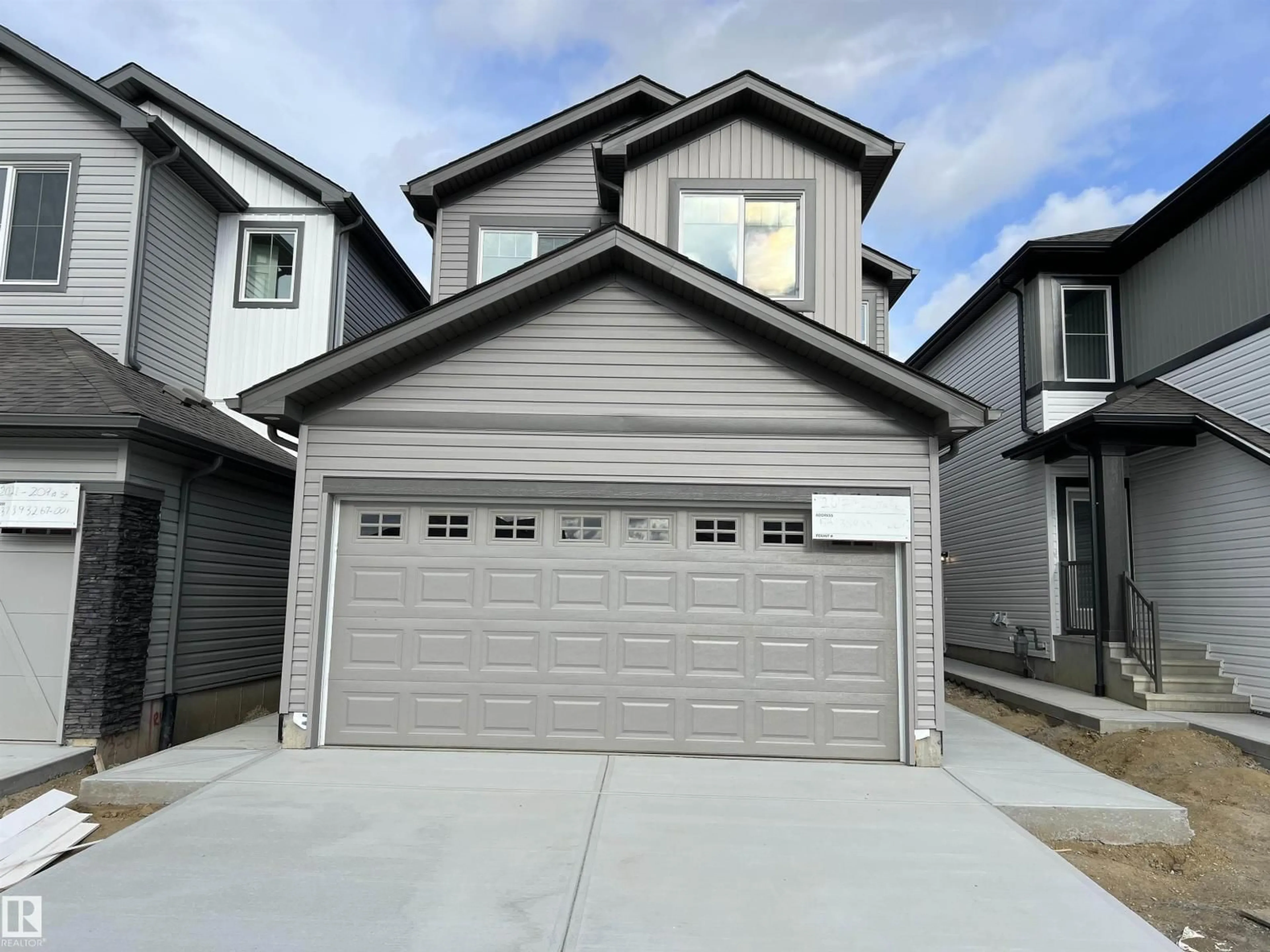 Home with vinyl exterior material, street for NW - 2017 209A ST, Edmonton Alberta T6M3C8
