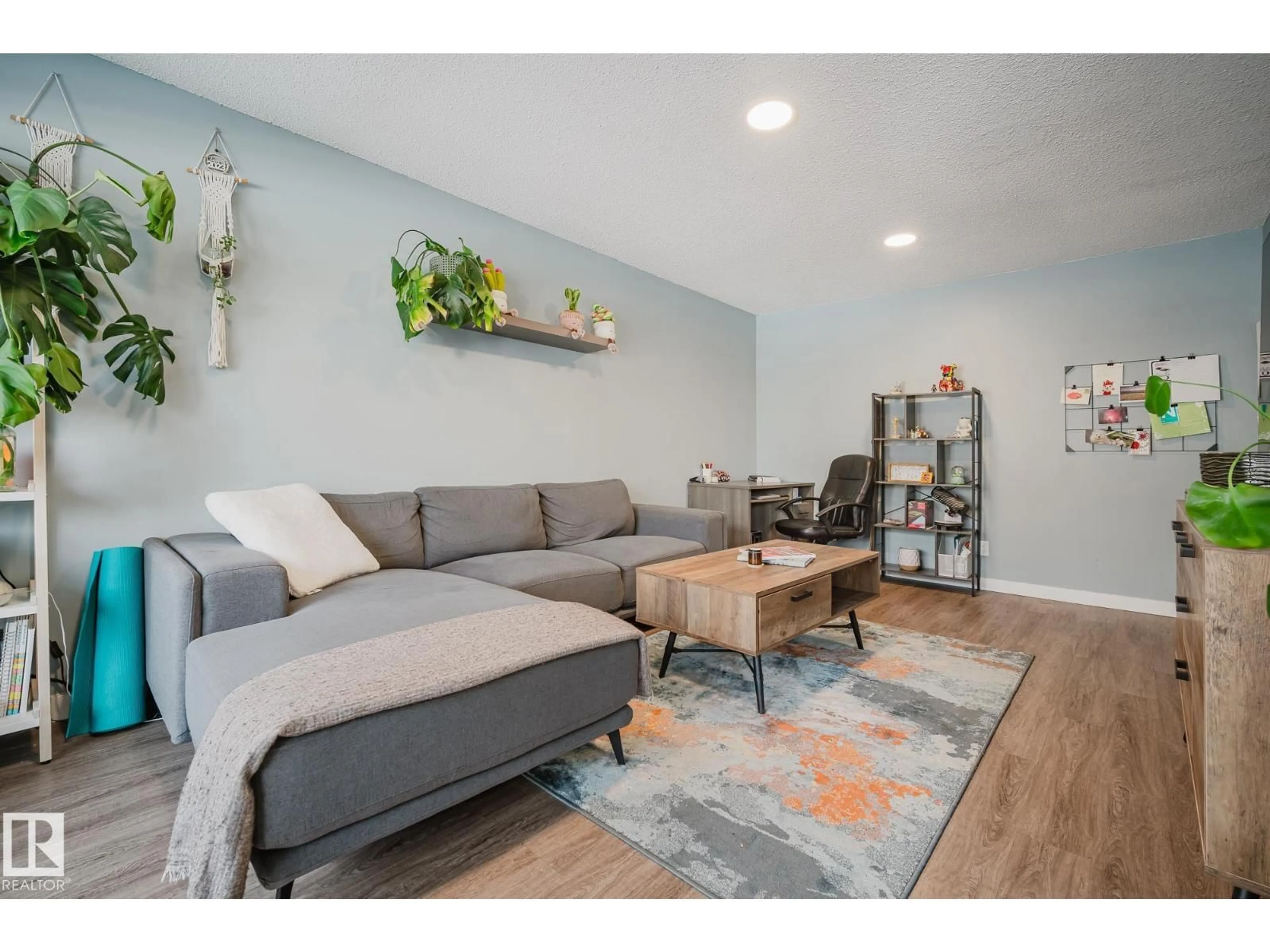 Living room with furniture, wood/laminate floor for 10149 83 AV, Edmonton Alberta T6E2C5