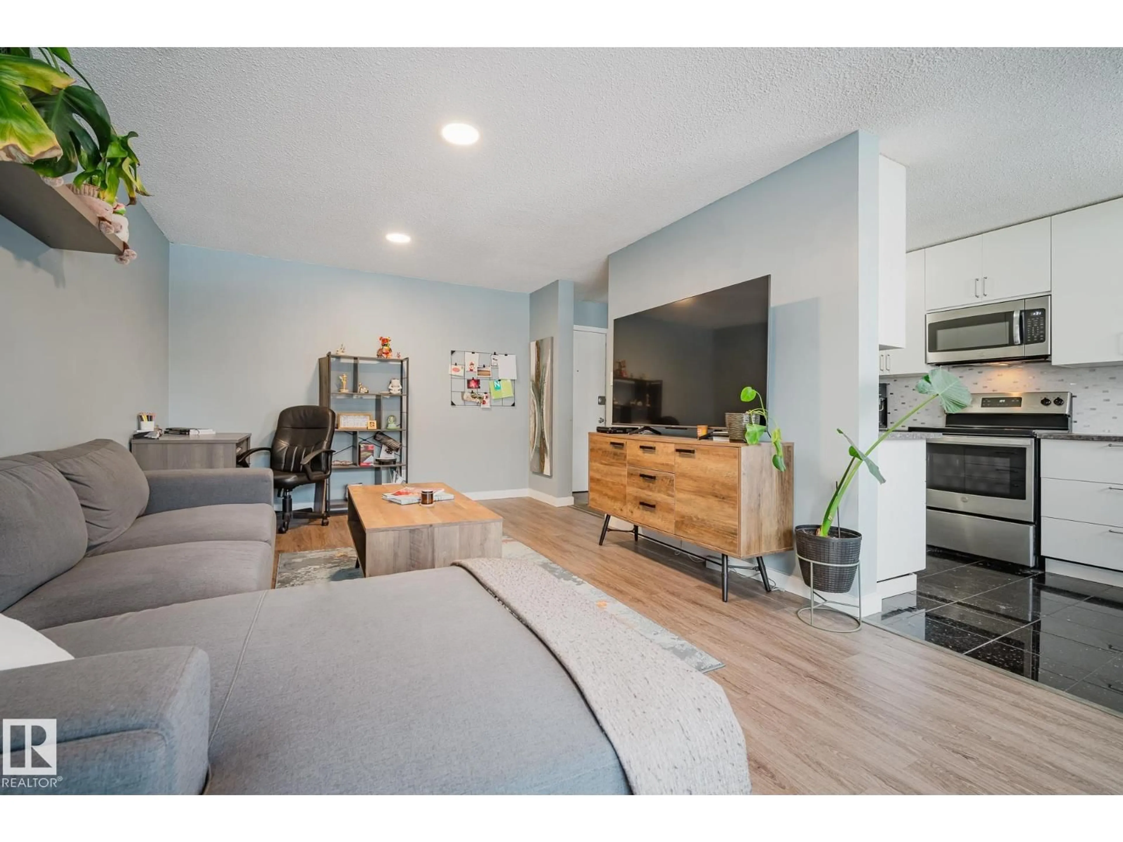 Living room with furniture, wood/laminate floor for 10149 83 AV, Edmonton Alberta T6E2C5